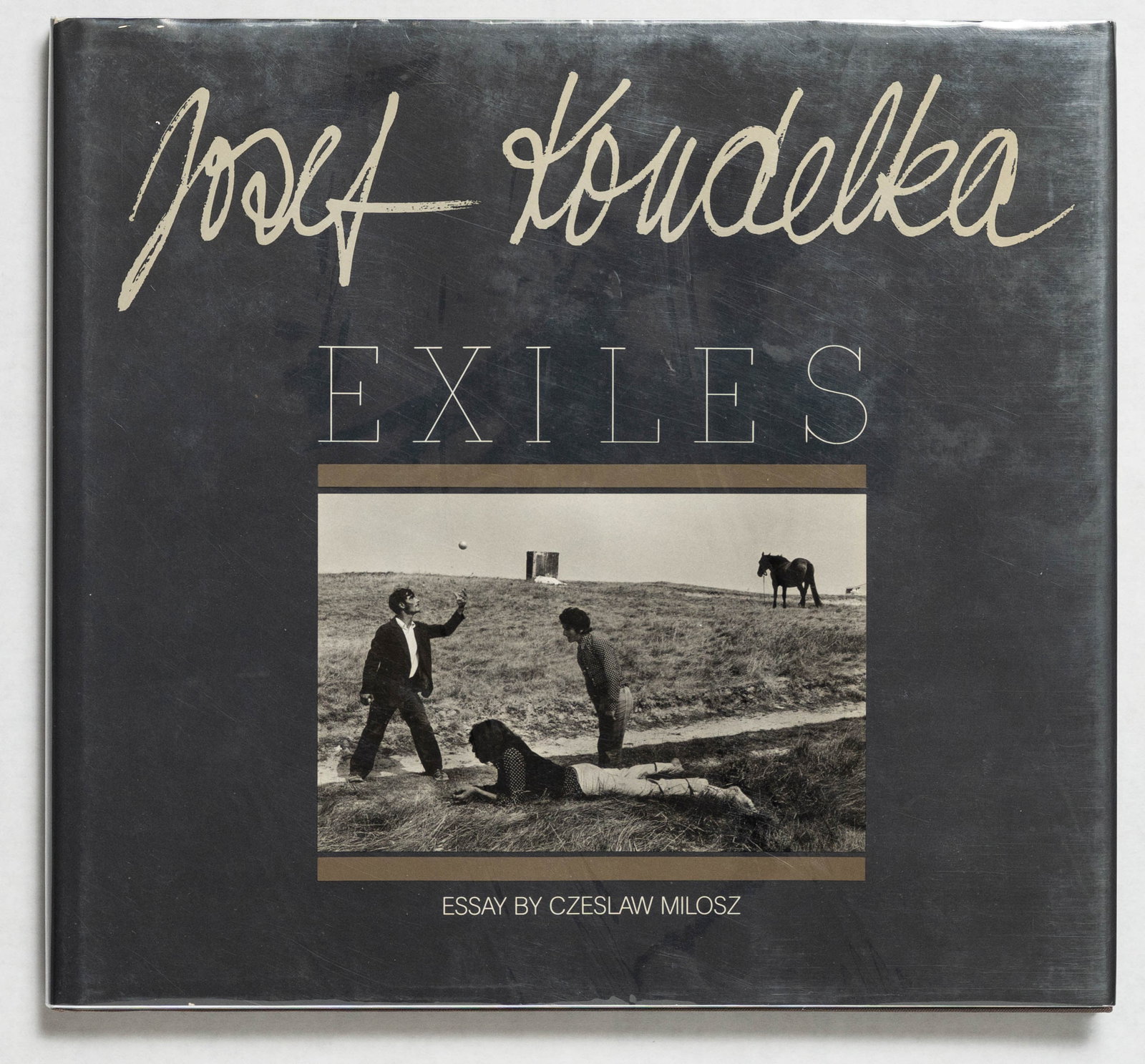 Koudelka, Josef; Exiles [SIGNED - 1988 APERTURE 1ST EDITION & 1ST PRINTING - FINE COPY]: SIGNED COPY Aperture, 1988. Hardcover in pictorial dust jacket. First Edition, First Printing. Photographs by Josef Koudelka. Prepared and designed by Robert Delpire. Essay by Czeslaw Milosz. Unpagina