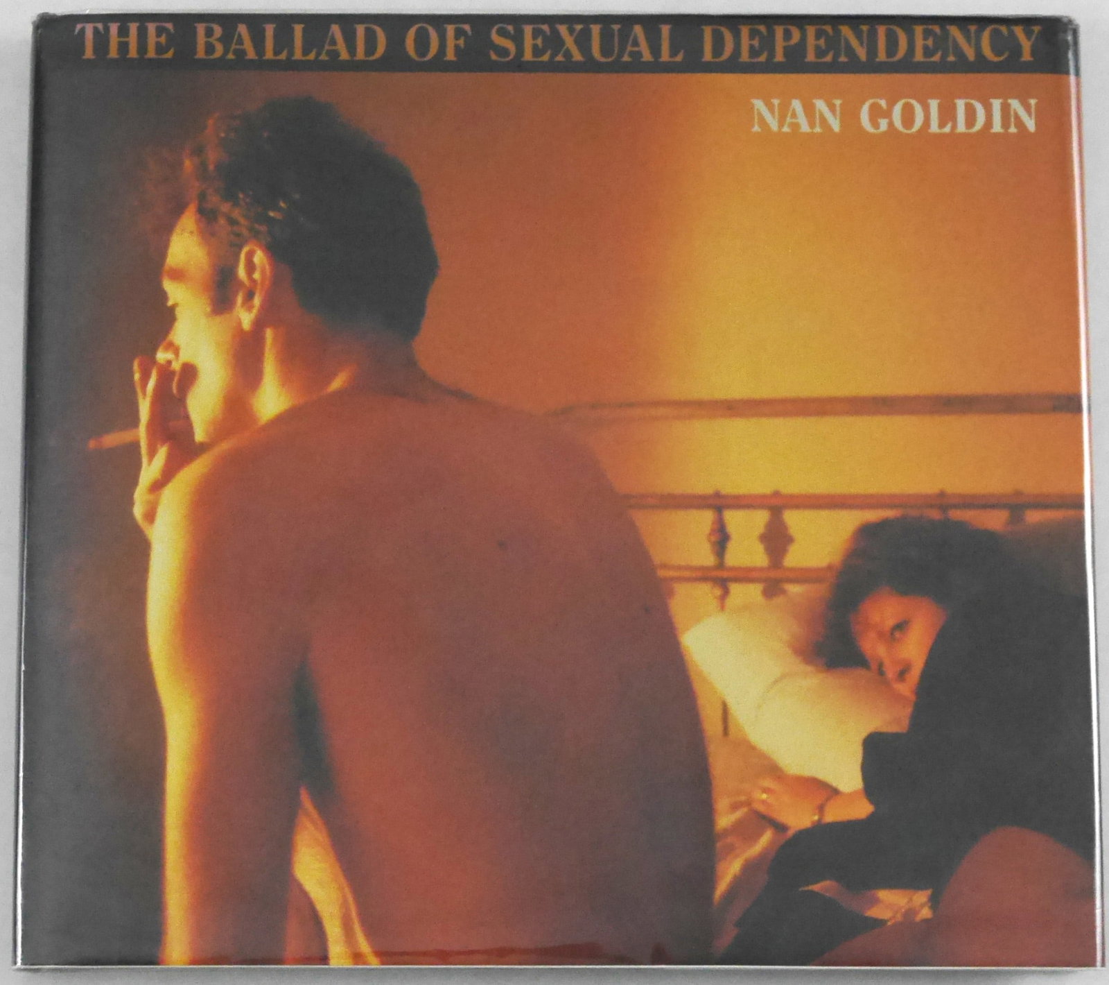 Goldin, Nan; The Ballad of Sexual Dependency [1986 HARDCOVER 1ST EDITION & 1ST PRINTING - FINE COPY]: New York: Aperture,, 1986. Hardcover in pictorial dust jacket. First Edition, First Printing. Edited with Marvin Heiferman, Hark Holborn, and Suzanne Fletcher. Oblong quarto. Original dark blue cloth-