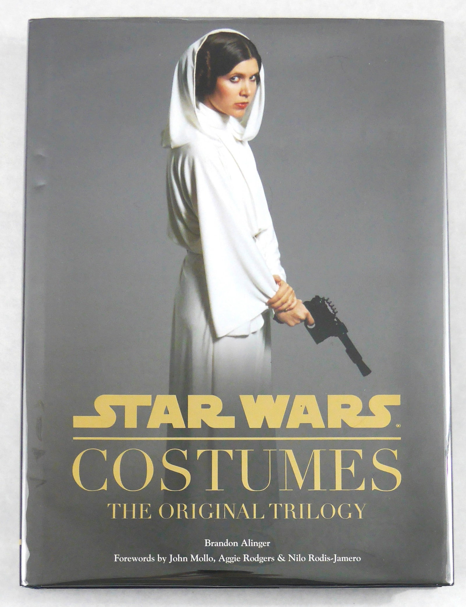 Alinger, Brandon; Star Wars Costumes, The Original Trilogy [2014 1ST EDITION - FINE]: Chronicle Books, 2014. Hardcover in pictorial dust jacket. First Edition, First Printing (with full numberline ending in 1). 12 x 10 inches. 225 pages (including several foldouts) with numerous photog