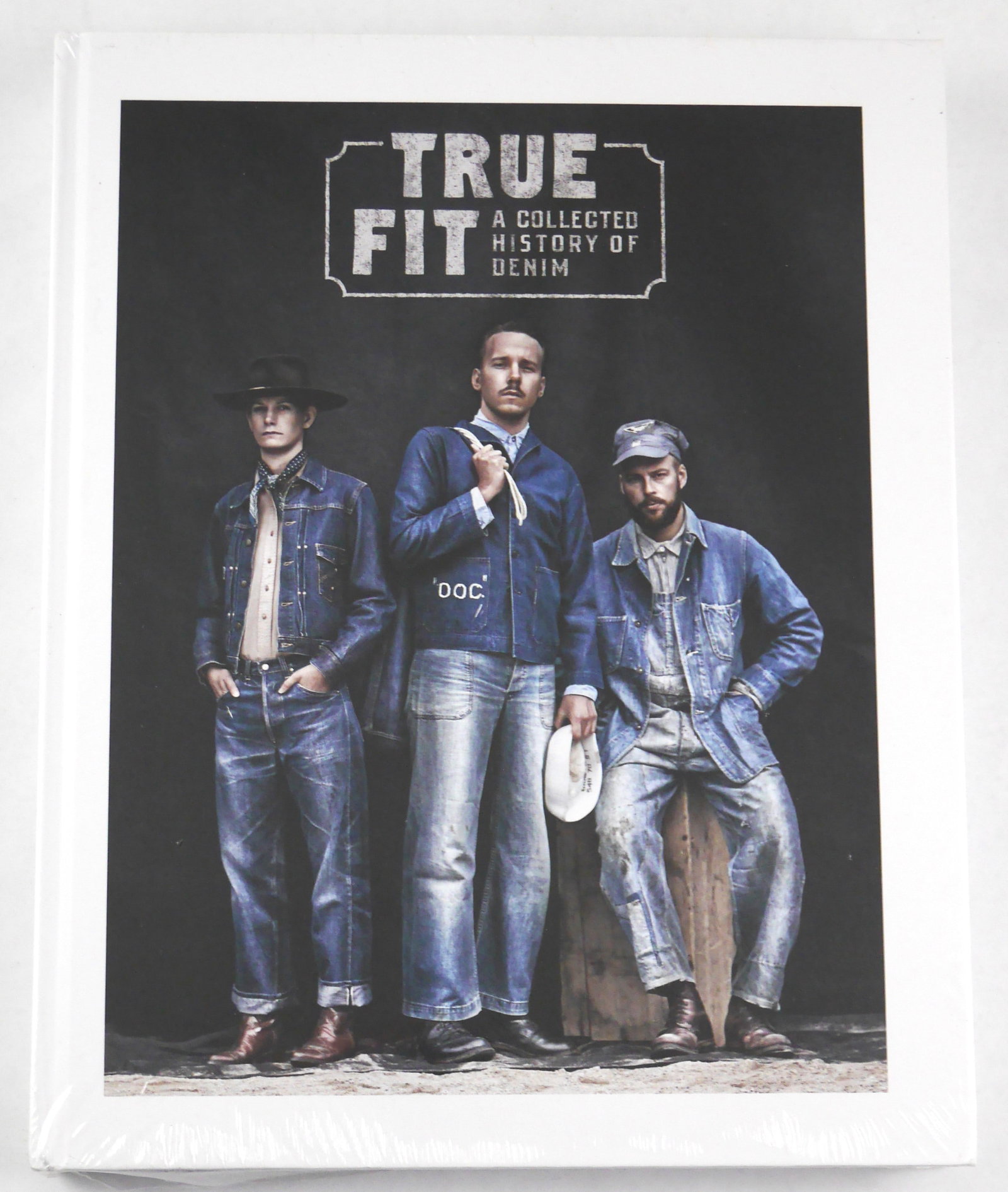True Fit. A Collected History of Denim [2017 1ST EDITION 1ST PRINTING - FINE COPY]: Graphera Publishers, 2017. Hardcover in pictorial boards. First Edition, First Printing. 12 x 10 inches. 268 pages with accompanying text by Viktor Fredback and numerous color photographic images thro
