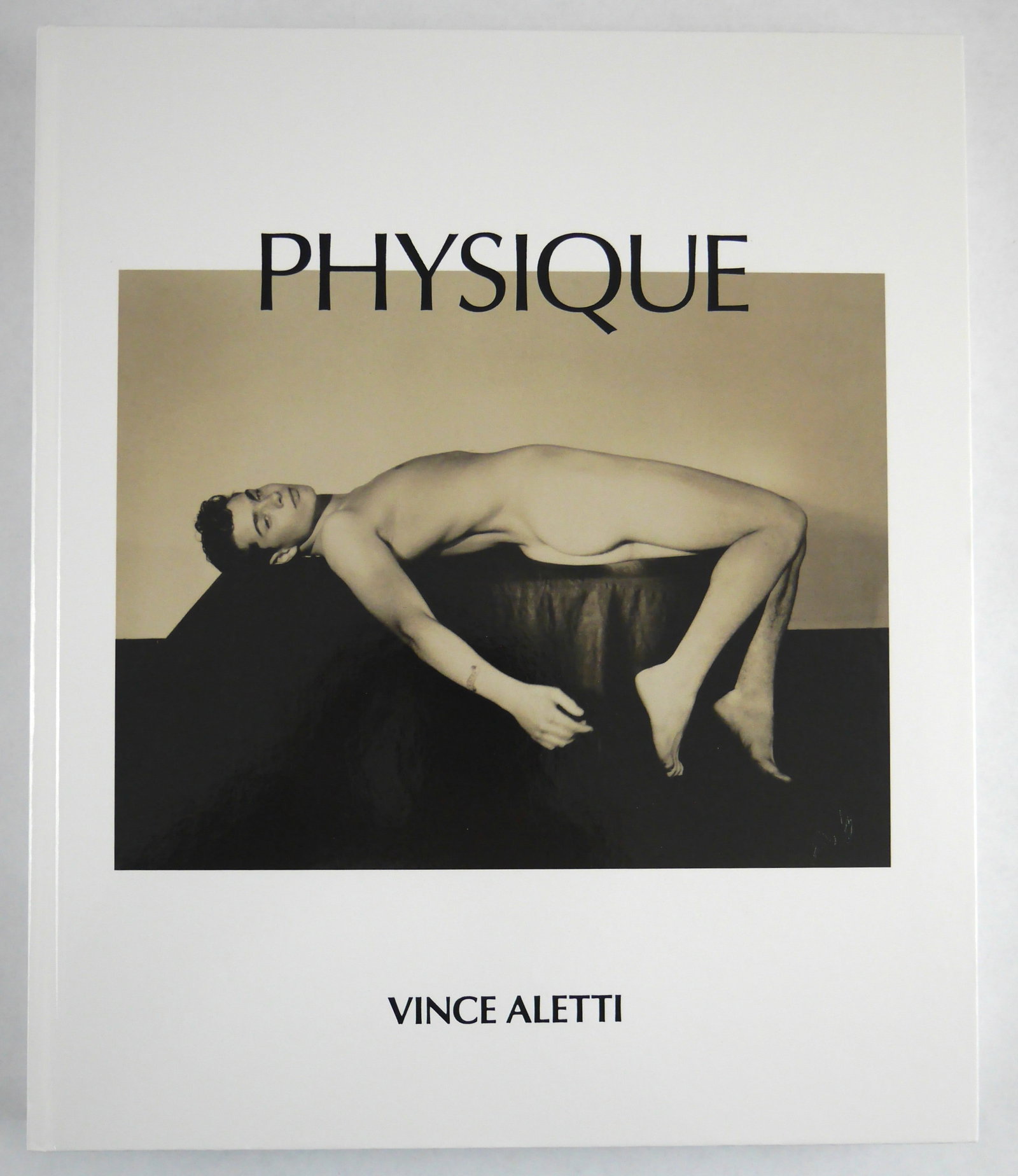 Aletti, Vince; Physique [SIGNED 2025 1ST EDITION 1ST PRINTING - FINE]: Self Publish Be Happy, 2025. Softcover with embossed flexibound covers with image to front cover. First Edition, First Printing. 224 pages showcasing Vince Aletti's collection of over 250 rare photogr