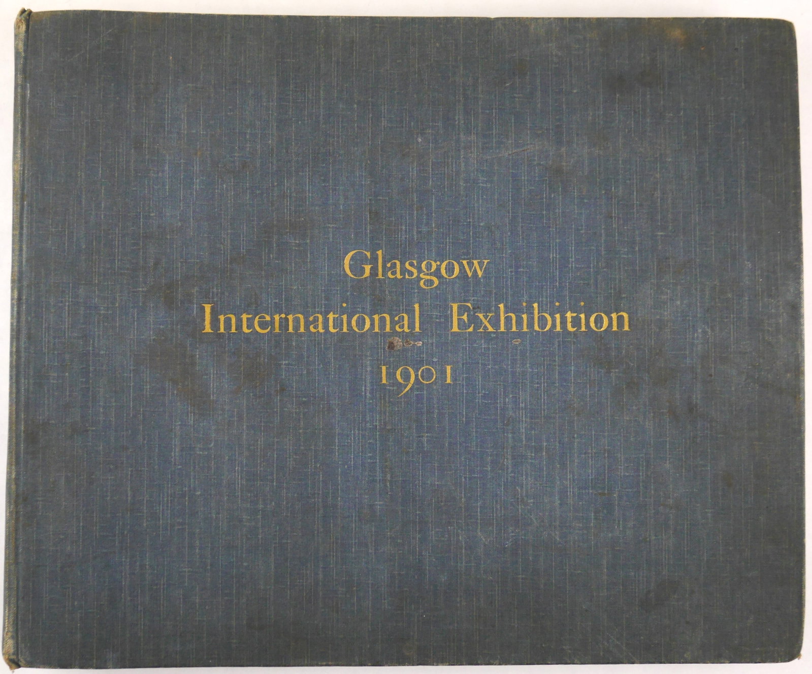 Thomas Annan, Glasgow International Exhibition, 1901 [RARE 1ST EDITION WITH ALL 20 SILVER PRINTS]: No piublisher listed, 1901. Hardcover in original blue cloth with titles in gilt to front cover. First Edtion. Oblong quarto, 12 x 10 inches (25.5 x 31 cm). Album of 20 silver prints mounted to stiff 