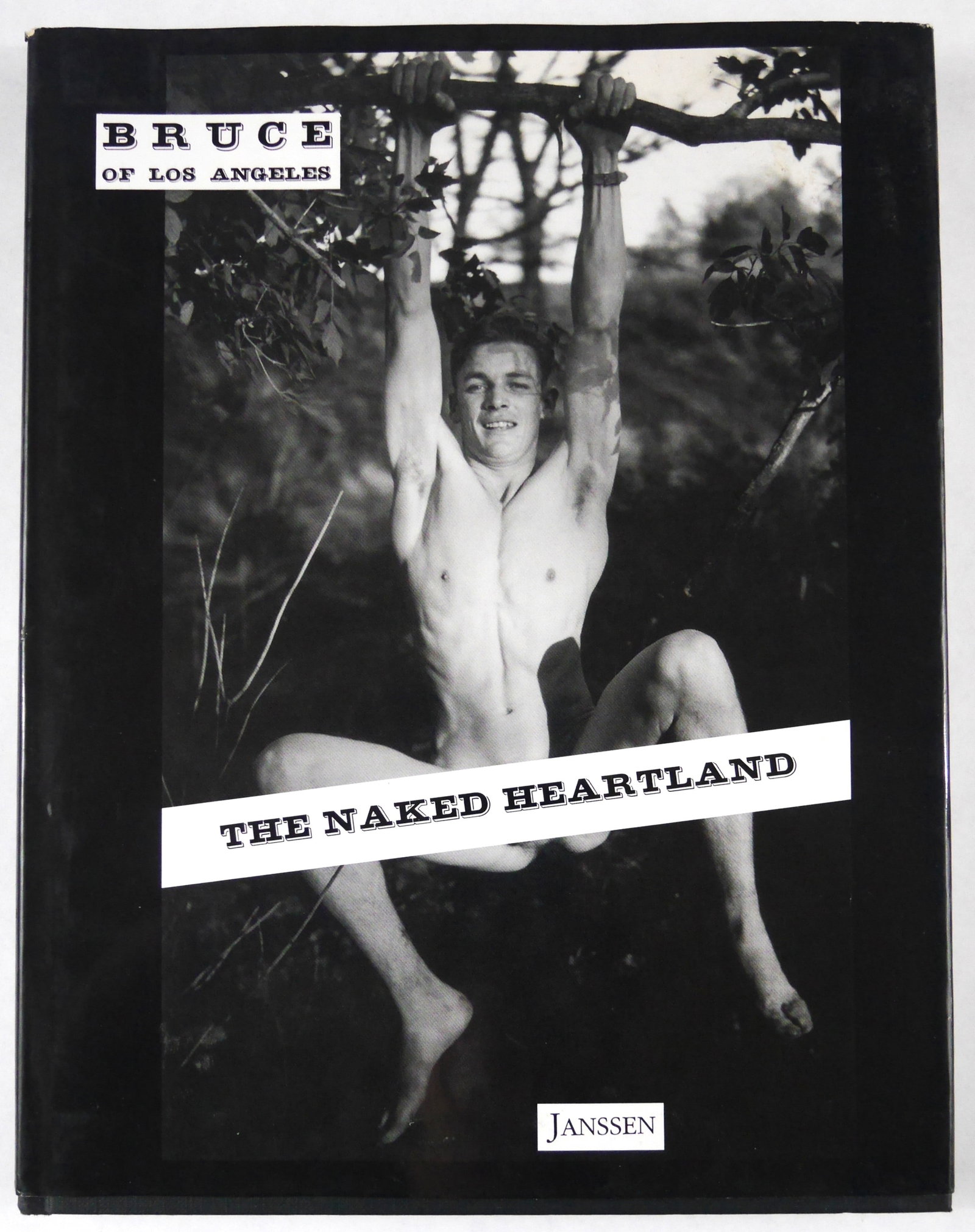 Bellas, Bruce; Bruce of Los Angeles, The Naked Heartland [2020 1ST EDITION - FINE]: Janssen, 2000. Hardcover in pictorial boards. First Edition, Firstr Printing. 128 pages with numerous black and white photographic images throughout. BOOK CONDITION: Fine; a solid, tight, clean copy i