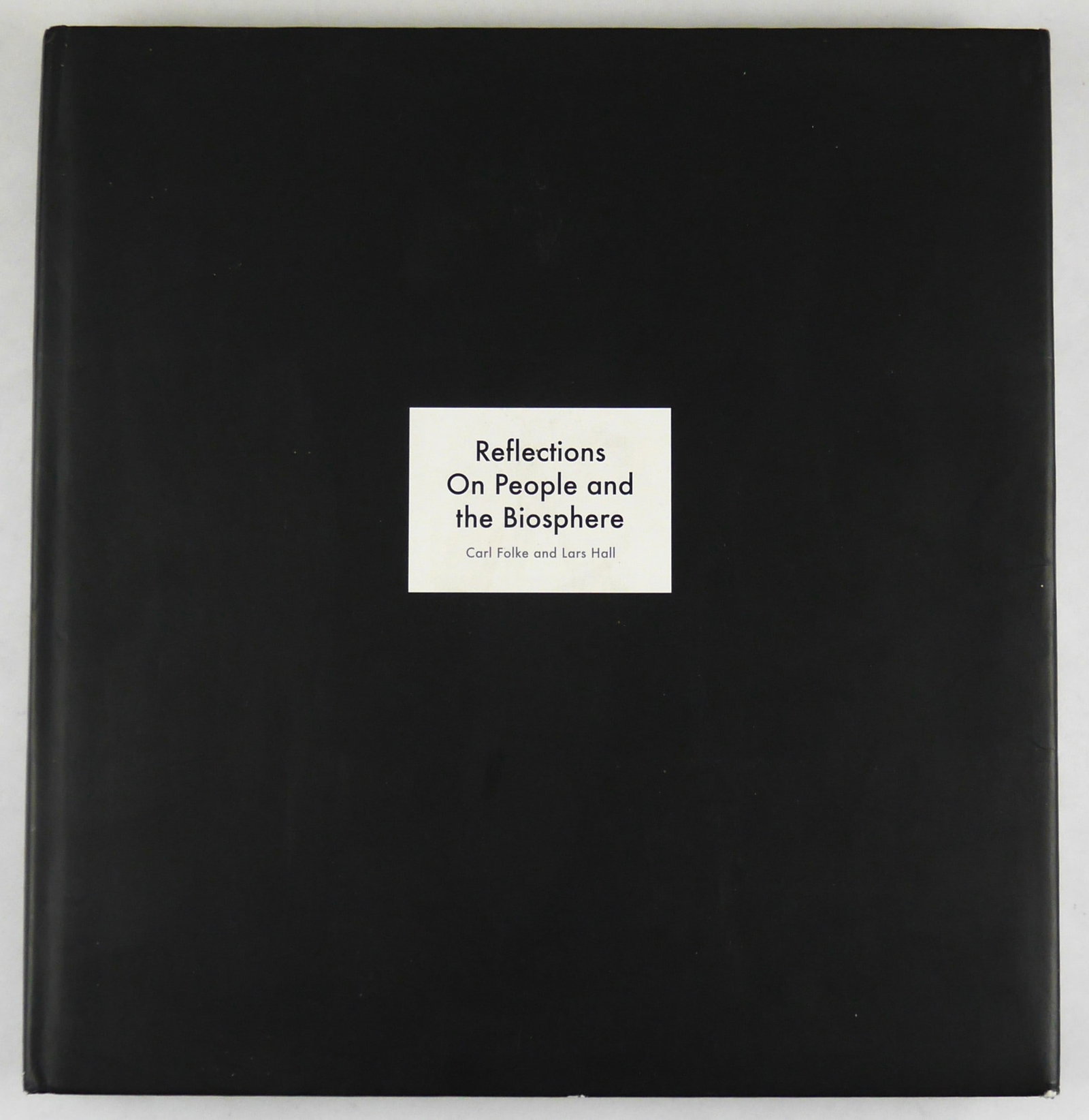 Folke, Carl; Hall, Lars; Reflections on People and the Biosphere [SIGNED by Carl Folke - 2014 1ST]: Bokförlaget Langenskiöld 2014. Hardcover in black dust jacket (includes a printed list thanking the musicians for permission to use parts of their song lyrics - laid in). First Edition, First Printi