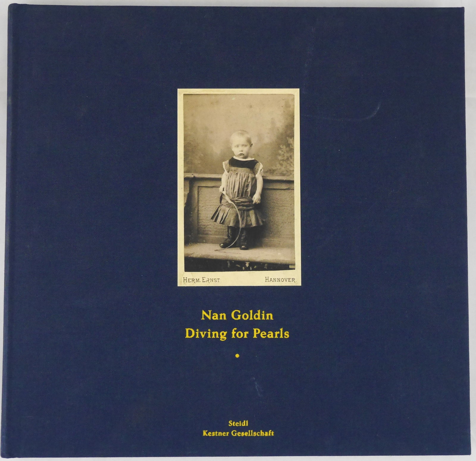 Goldin, Nan; Diving for Pearls [2016 1ST EDITION - FINE]: Steidl, 2016. Hardcover in cloth boards with tipped-in image to front cover. First Edition, First Pritning. 208 pages filled with color photogrphic images throughout. BOOK CONDITION: Fine; a solid, ti