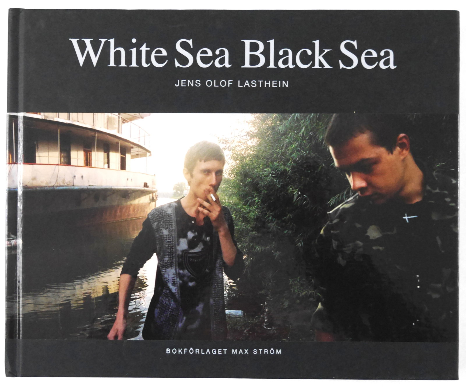 Lasthein, Jens Olof; White Sea Black Sea (A Visual Journey Eastern Border of the European Union): Stockholm, Max Ström, 2008. Hardcover in pictorial boards. First Edition. 12 x 8 inches. 5 pages of introductiory text by Lasthein in Swedish. 170 pages offering 79 full-bleed, double-page panoramic 