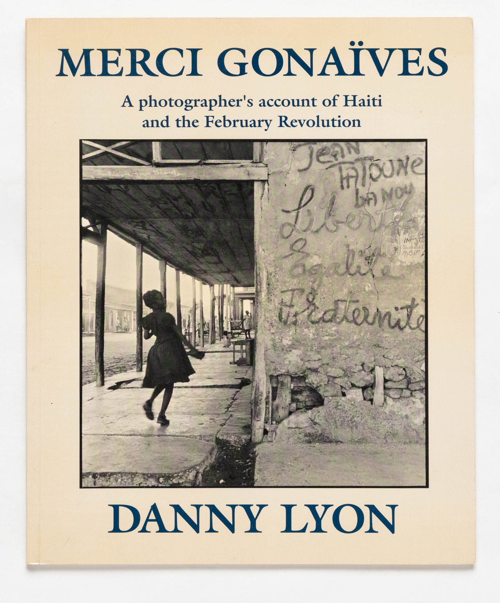 Lyon, Danny; Merci Gonaives [SIGNED 1988 1ST EDITION - FINE]: Bleak Beauty Books, 1988. Softcover in pictorial wrappers. First Edition, First Printing. 61 pages with numerous black and white photographic images throughout Danny Lyon's account of the fall of the 