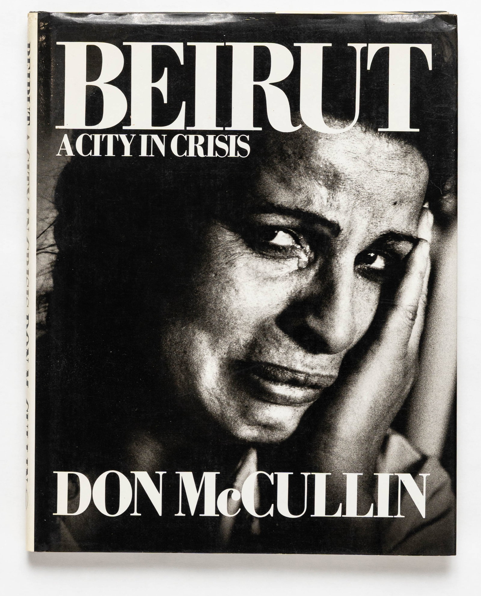 Don Mccullin, Beirut, A City in Crisis [SIGNED 1983 1ST EDITION 1ST PRINTING - FINE]: New English Library, 1983. Hardcover in pictorial dust jacket. First Edition, First Printing. 11 x 09 inches. 128 pages filled with black and white photographic images throughout. A seminal photobook 