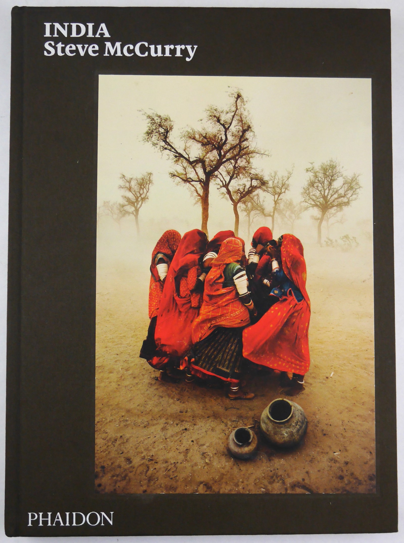 McCurry, Steve; India [SIGNED 2015 1ST EDITION 1ST PRINTING - FINE]: Phaidon, 2015. Hardcover in brown cloth boards with tipped-in image to front cover. First Edition, First Printing. 209 pages with 96 color photogaphic images throughout by Steve McCurry. SIGNED/INSCRI