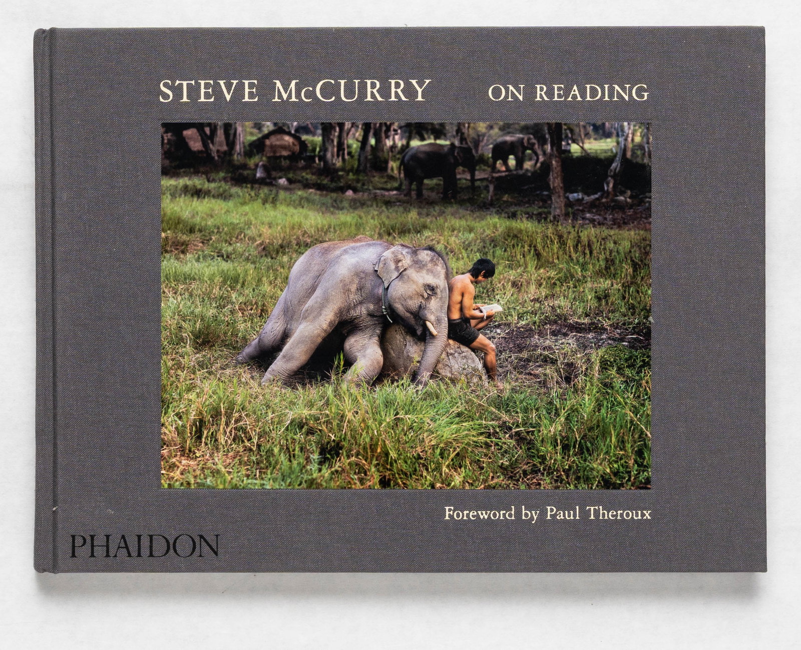 Steve McCurry, On Reading [2016 1ST EDITION 1ST PRINTING - FINE]: Phaidon Press, 2016. Hardcover in cloth boards with tipped-in images to front cover. First Edition (stated), First Printing. 9 x 12 inches. 140 pages with 70 color photographic images of people in teh