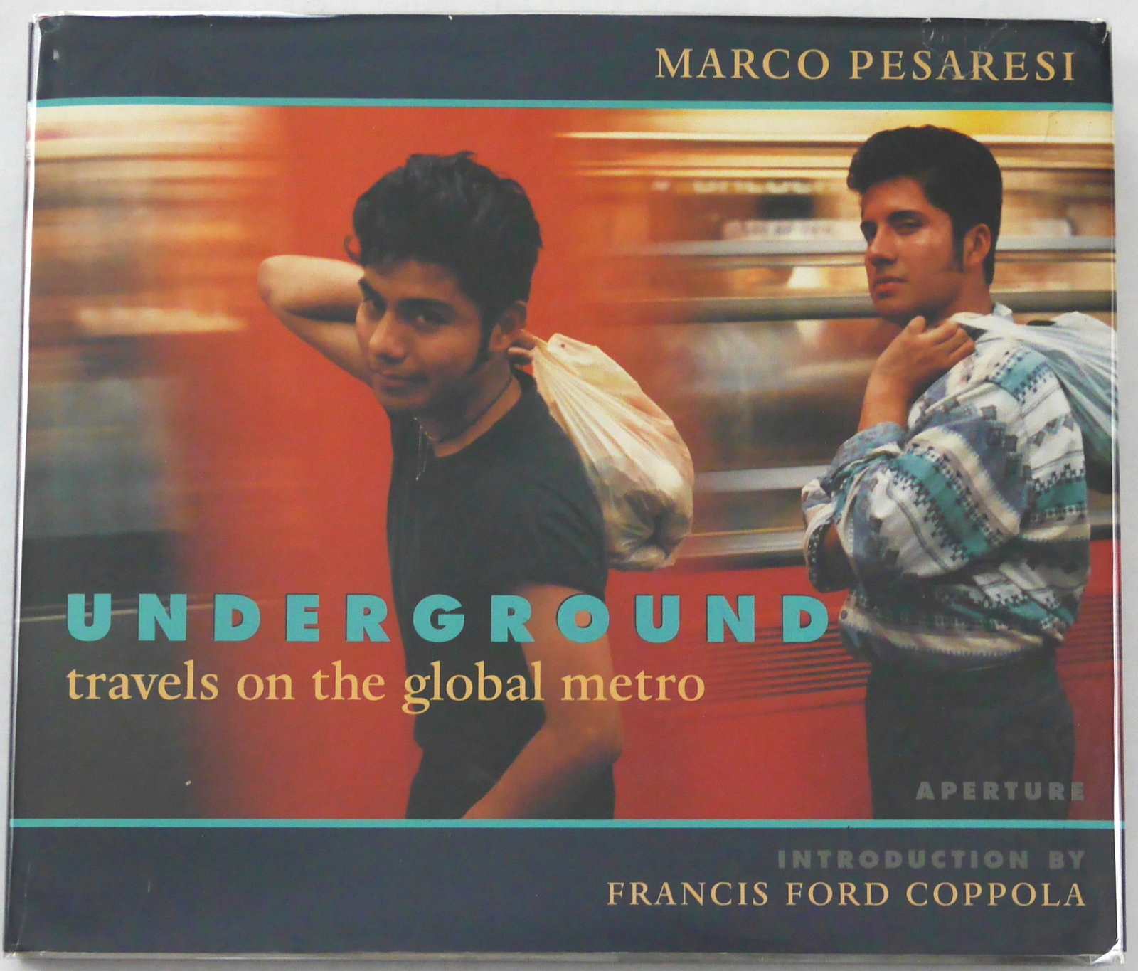 Pesaresi, Marco; Francis Ford Coppola; Underground: Travels on the Global Metro [1998 1ST EDITION: Aperture, 1998. Hardcover in pictorial dust jacket. First Edition, First Printing (with the full numberline ending in 1). 12 X 10 inches. 128 pages with numerous color photographic images throughout. 