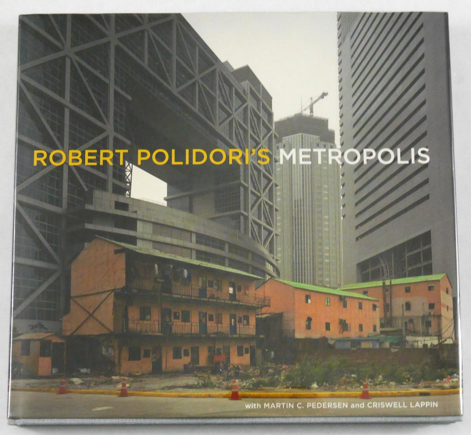 Polidori, Robert; Metropolis [SIGNED 2004 1ST EDITION 1ST PRINTING - FINE]: SIGNED COPY - Metropolis Books, 2004. Hardcover in pictorial dust jacket. First Edition, First Printing.? 13 x 11 inches. 142 pages with 93 color photographic images throughout accompanied by an essay