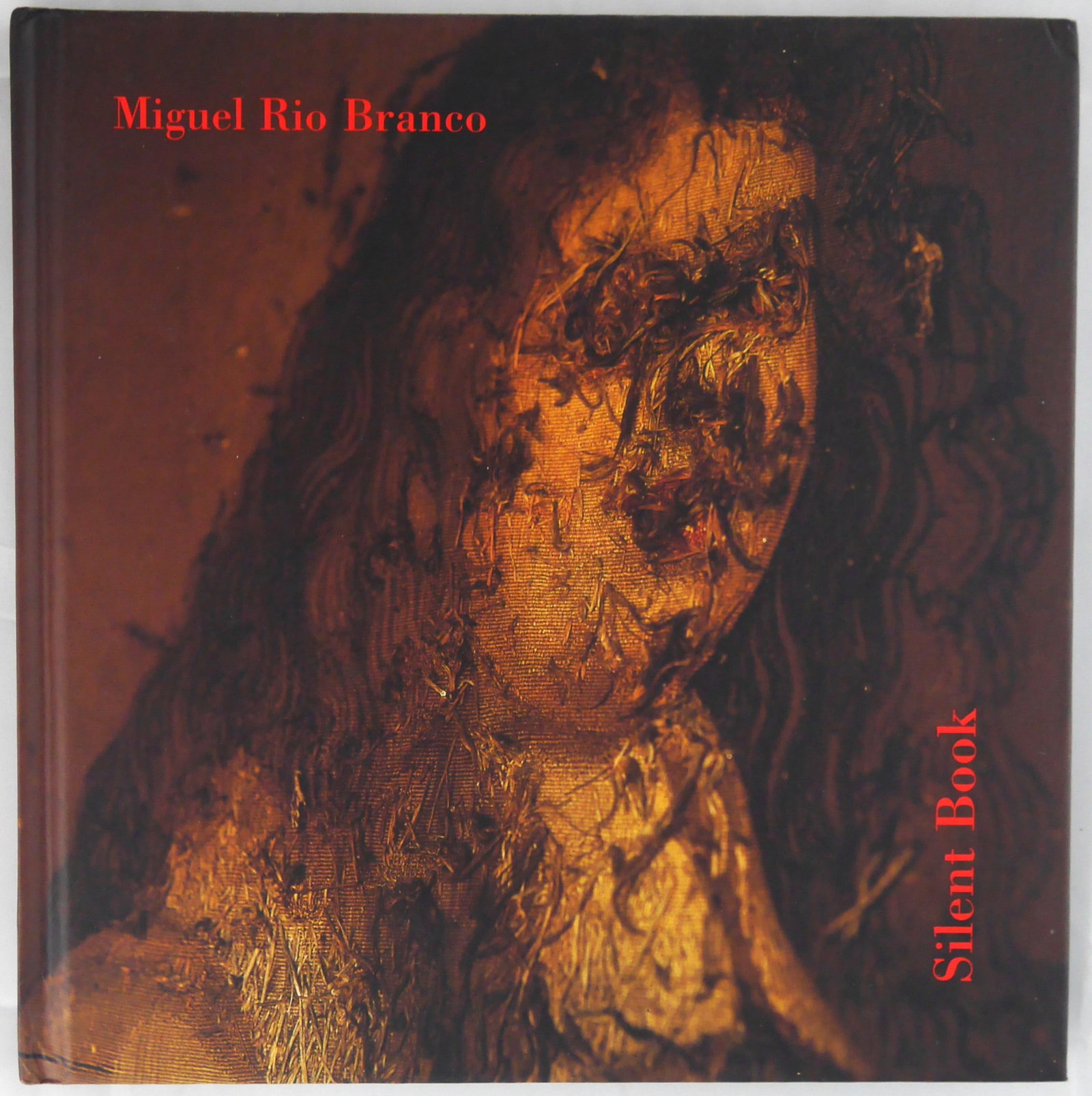 Rio Branco, Miguel; Silent Book [SIGNED - 1ST EDITION & 1ST PRINTING]: SIGNED COPY Sao Paulo: Cosac & Naify 1997. Hardcover with pictorial boards. First edition, first printing. 98 pages with 75 colour photographs and 3 gate folds. Design by Jean Yves Cousseau. Cited in 