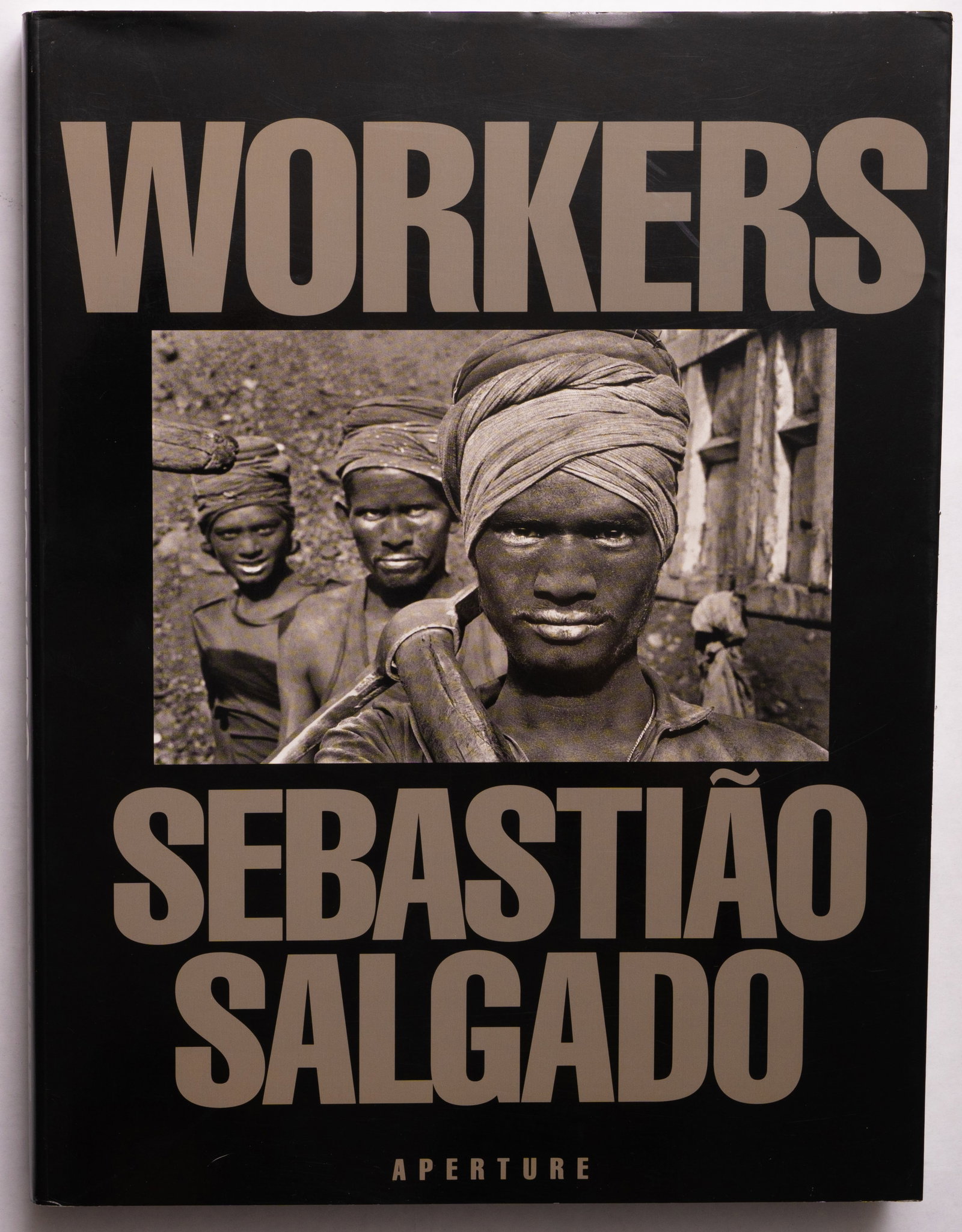 Sebastiao Salgado, Workers [SIGNED1993 1ST EDITION SOFTCOVER - FINE]: SIGNED COPY Aperture. 1993. Softcover in pictorial dust jacket. First Edition, Later Printing. 400 pages with 350 duotone images and 8 eight-page gatefolds. SIGNED/INSCRIBED by Salgado on the half tit