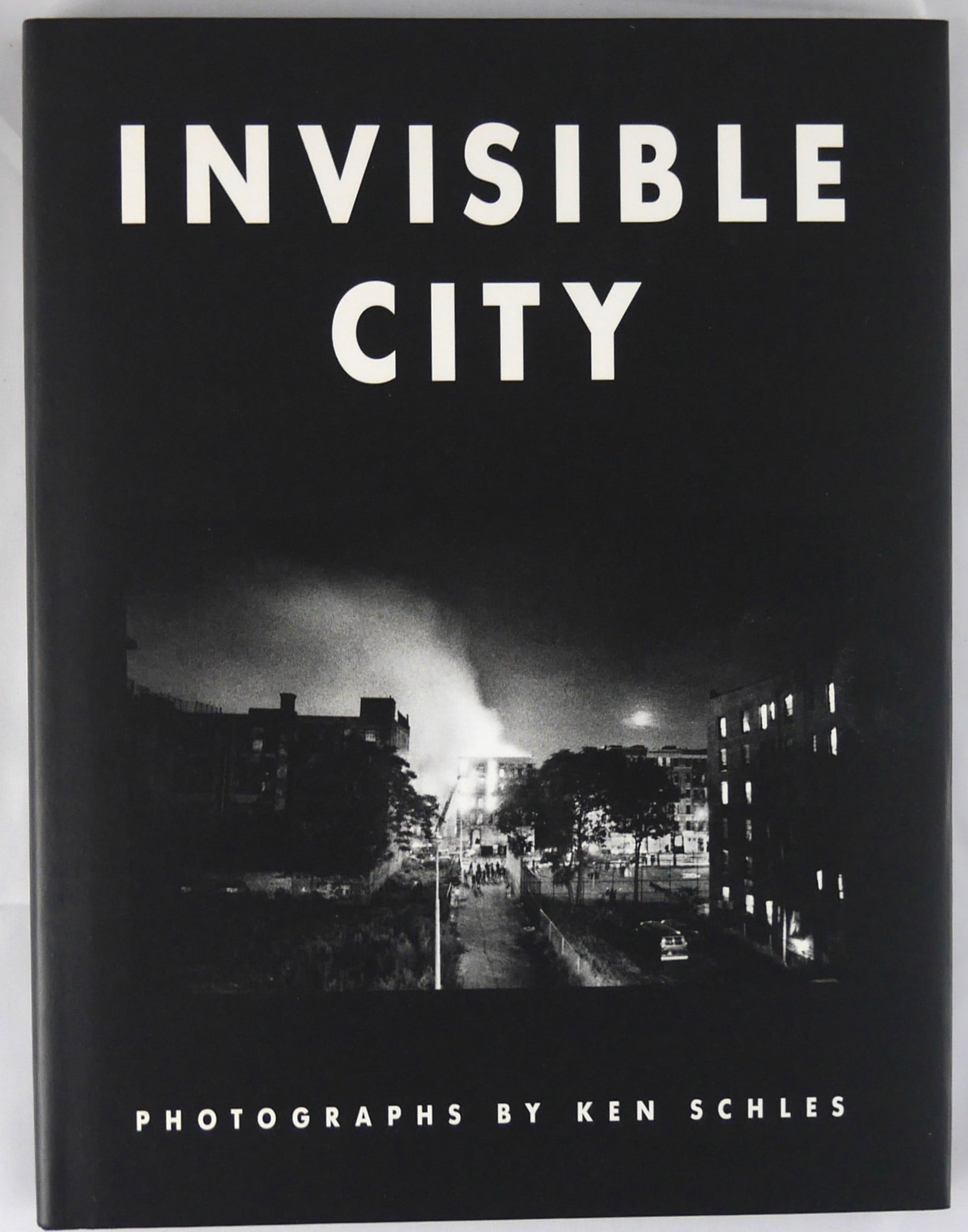 Schles, Ken; Invisible City [SIGNED - 2014 STEIDL EDITION]: SIGNED COPY Gottingen, Germany, Steidl, 2014. Hardcover in pictorial dust jacket. Second Edition. 80 pages with numerous black and white full-page photographic images throughout. SIGNED by Ken Schles.