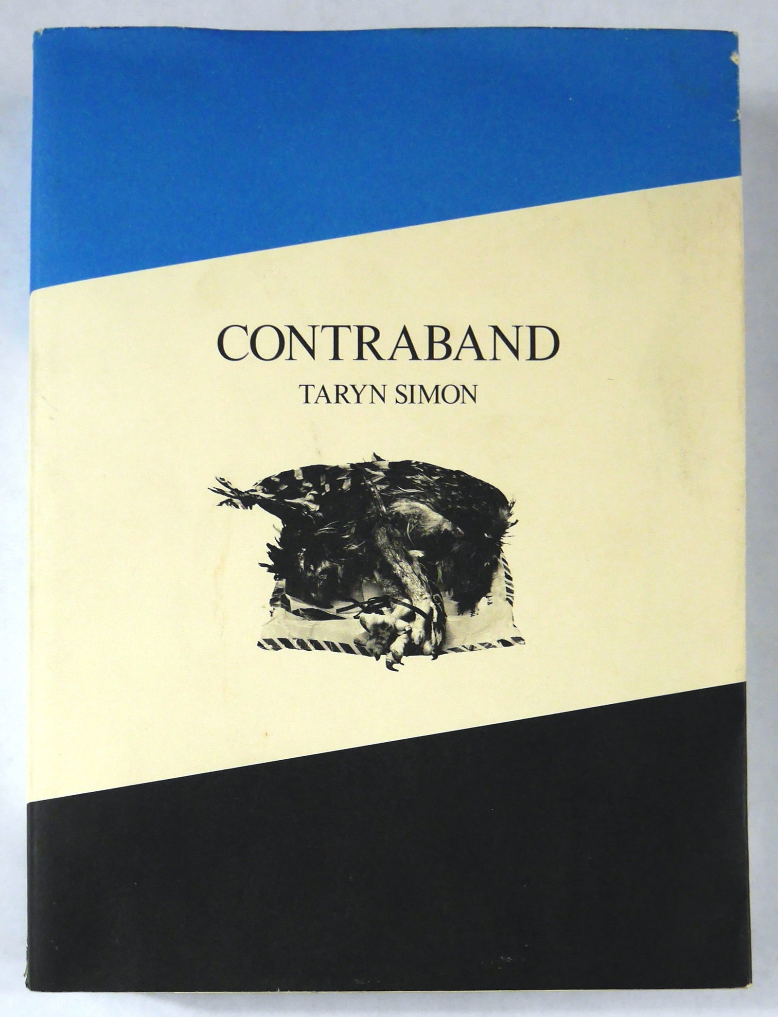 Taryn Simon, Contraband [SIGNED 2010 1ST EDITION 1ST PRINTING - BLUE VERSION]: SIGNED COPY - Steidl, Germany, 2010. Softcover in printed dust jacket (this jacket being the blue version). First Edition (stated), First Printing. 10 x 8 inches. 249 pages with numerous photographic 