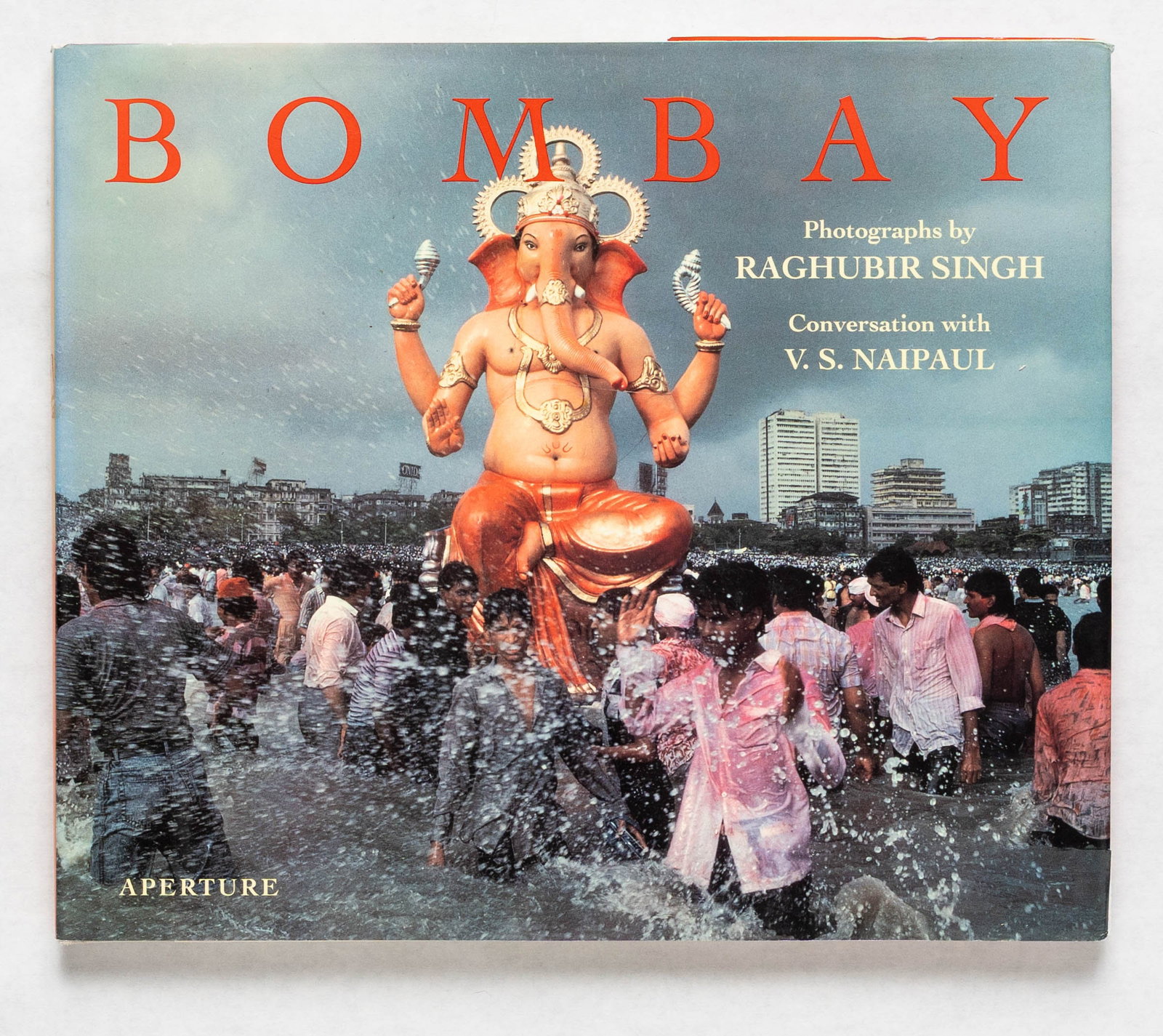 Singh, Raghubir; Naipaul, V, S.; Bombay [1ST EDITION 1ST PRINTING]: Aperture, 1994. Hardcover in pictorial dust jacket. First Edition, First Printing. 11 x 9 inches. 120 pages with numerous color photographic images throughout. The Indian photographer Raghubir Singh, 