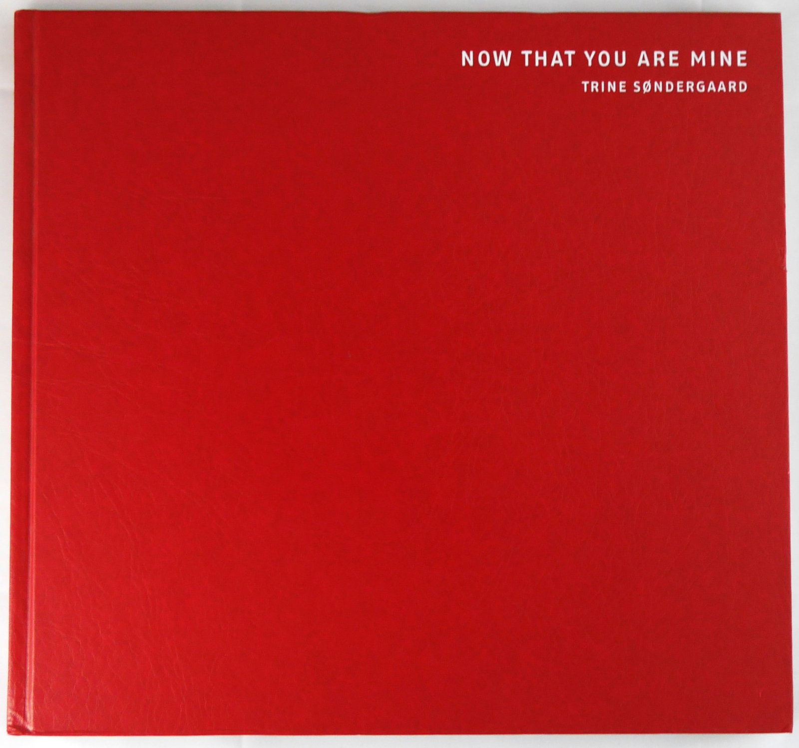 Sondergaard,Trine; Now That You Are Mine [2003 1ST EDITION & 1ST PRINTING - FINE COPY]: Steidl, 2002. Hardcover in red leatherette boards with title in white to front panel and spine. 72 pages with numerous photographs taken by Sondergaard in the Skelbaekgade area of Copenhagen Denmark f
