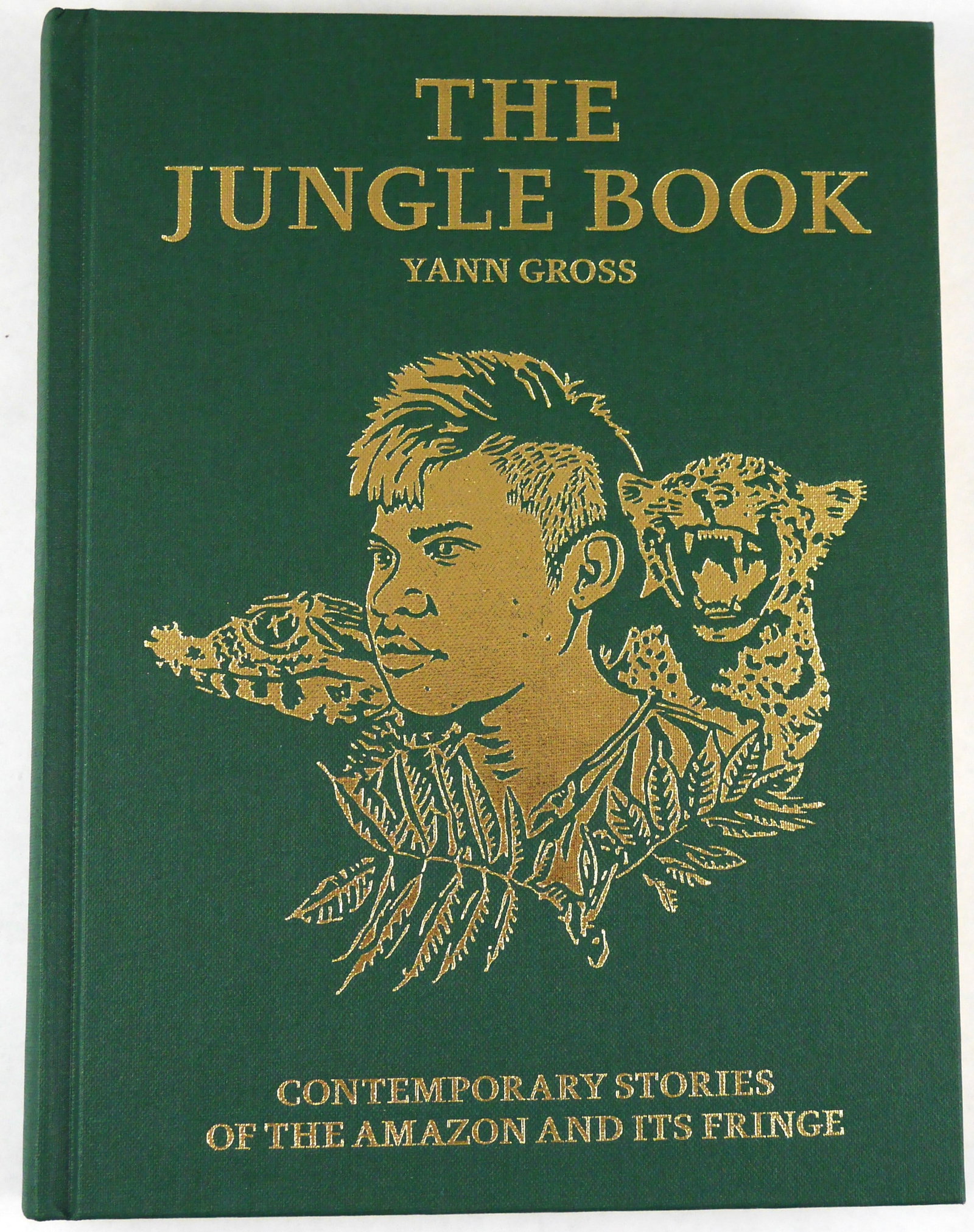 The Jungle Book: Contemporary Stories of the Amazon and It's Fringe [2015 1ST ED WITH MAP - FINE]: New York: Aperture, 2016. Hardcover in green cloth with gilt image and title to covers and gilt to edges of text block. First Edition, First Printing (with full numberline ending in 1). Small Quarto. 