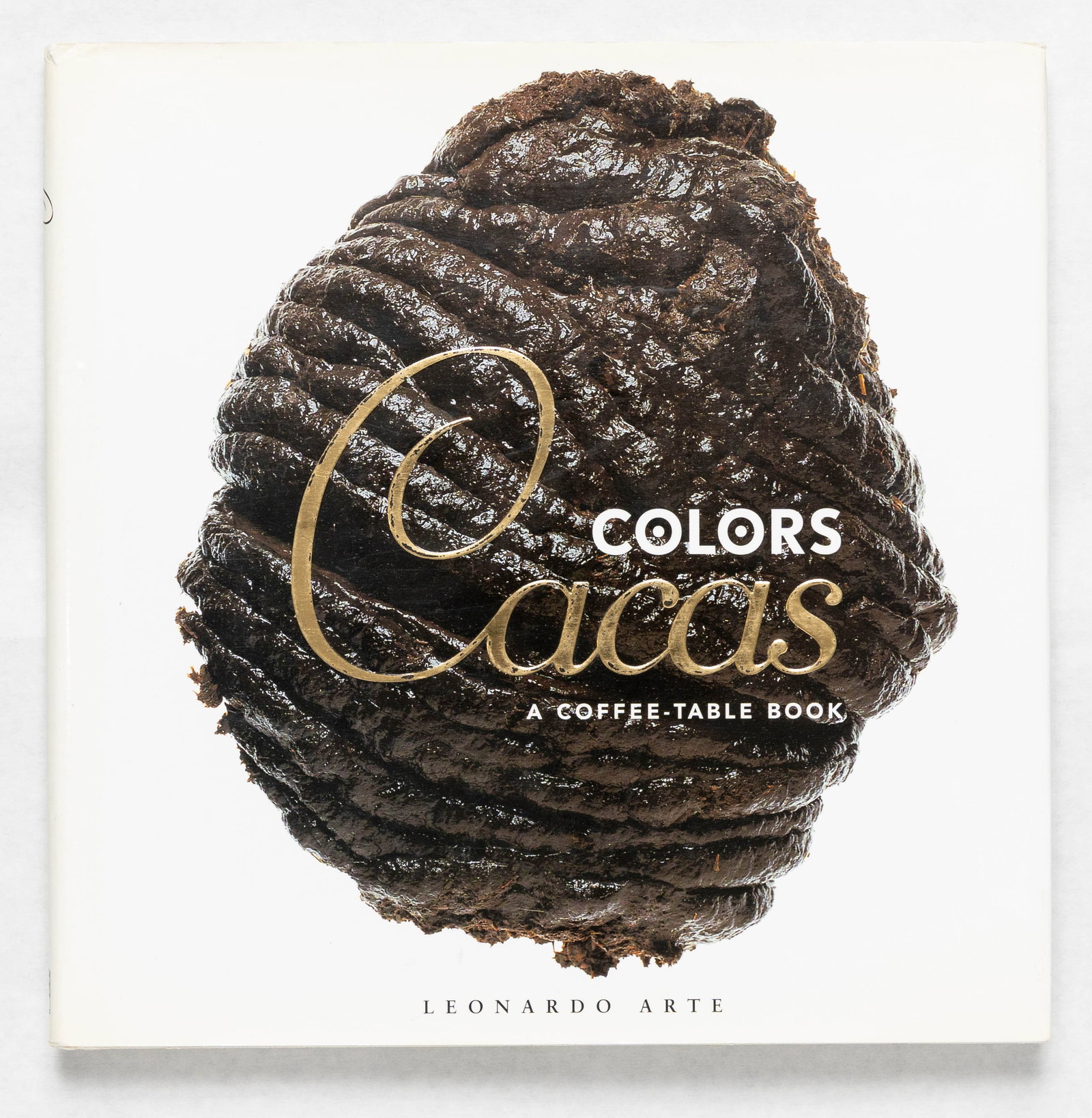 Toscani, Oliviero; Cacas [1998 - TRUE 1ST EDITION & FIRST PRINTING]: Colors Cacas: A Coffee-Table Book. Conceived by Oliviero Toscani. Photographs by Mariosa Toscani Ballo. Designed by Thomas Hilliard. Edited by Rose George. Leonardo Arte, Posano, 1998. 120 pp. Large q