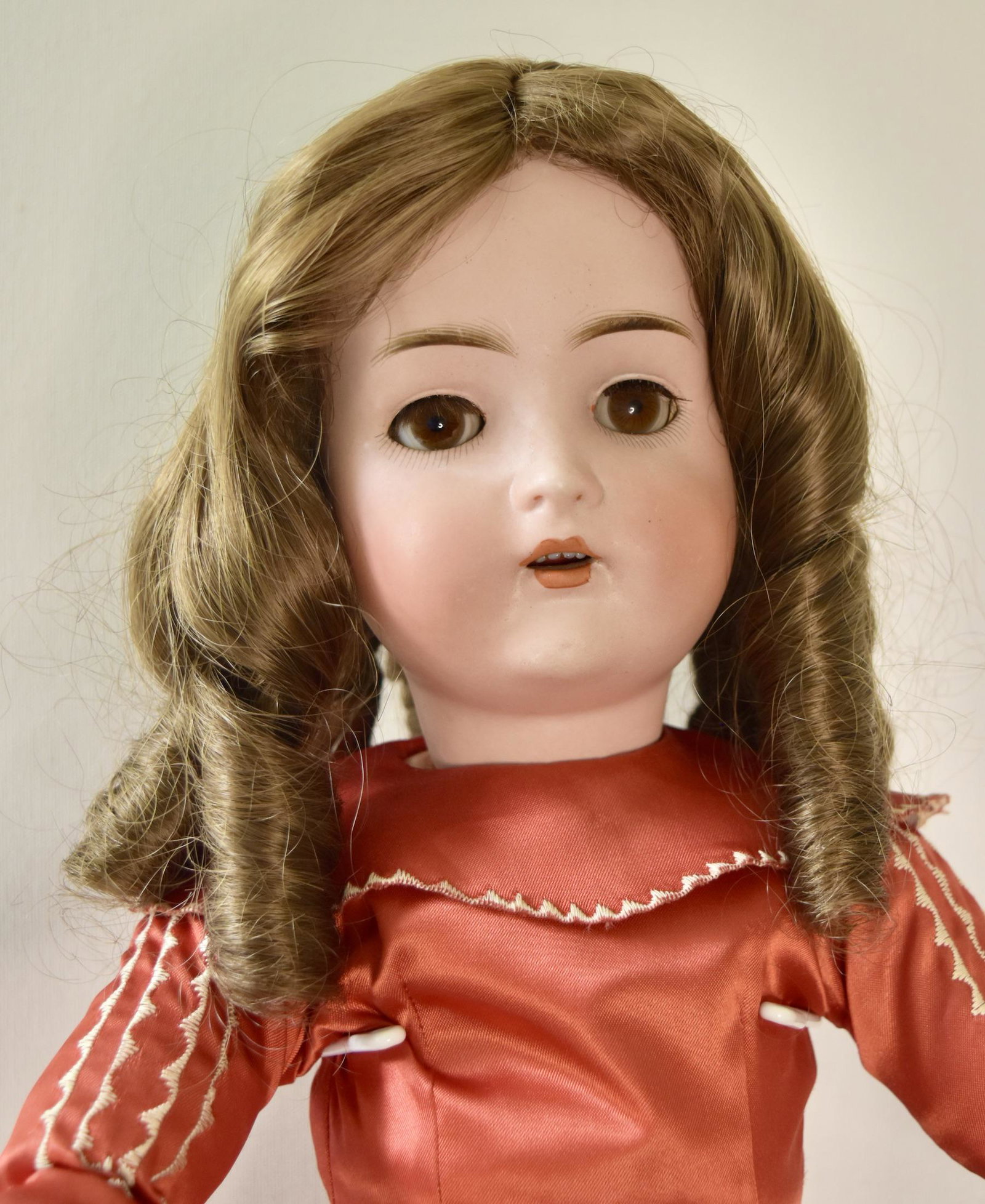 Bruno Schmidt 21.5” tall: Bruno Schmidt, 21.5” tall, Brown sleep eyes, open mouth with teeth, original jointed body, red satin dress with white embroidery, vintage slip, white shoes and socks, marked BSW in heart. Value