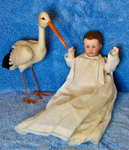 Heubach bisque baby with flocked hair, 5.5 inch with Steiff stork: G. Heubach bisque baby with flocked hair, 5.5 inch, unfinished bisque body, nice bisque character face, painted eyes, closed mouth, long white vintage baby gown and slip. Steiff Stork included with ba