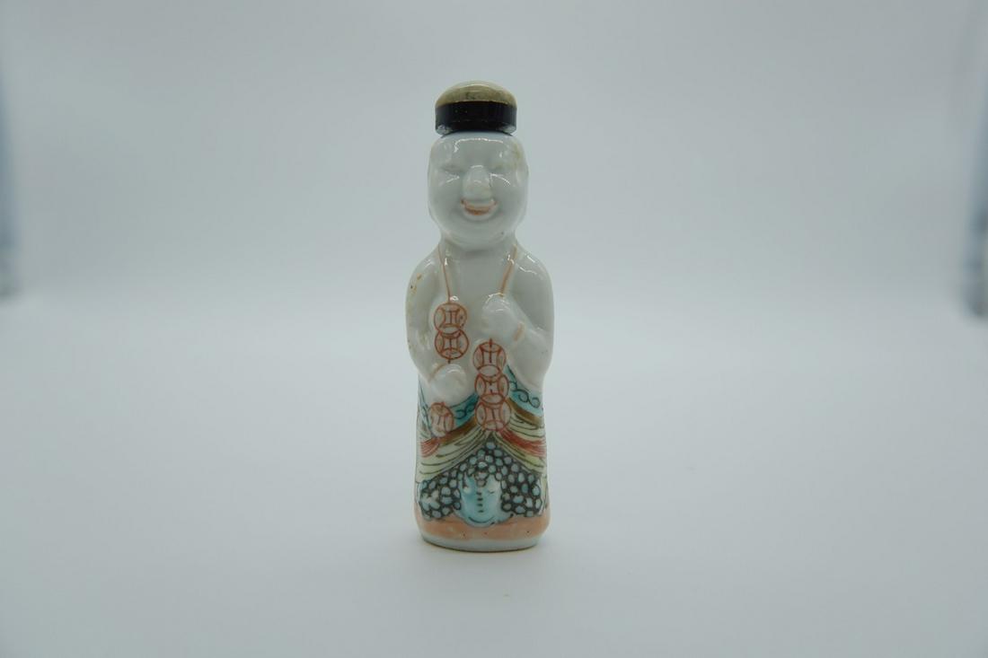 Porcelain molded LiuHai ride golden toad with a string of coins snuff bottle: The famille rose porcelain molded Liu Hai, a string of coins, and a golden toad snuff bottle. This story of Liu Hai playing with the golden toad has been passed down among the people in China. It orig