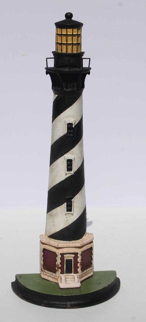 C 1920-40 cast iron lighthouse doorstop in original: C 1920-40 cast iron lighthouse doorstop in original paint. Depicting Cape Hatteras Light, Hatteras, NC, tallest brick lighthouse in America. Excellent untouched original condition (one widowâ€™s 