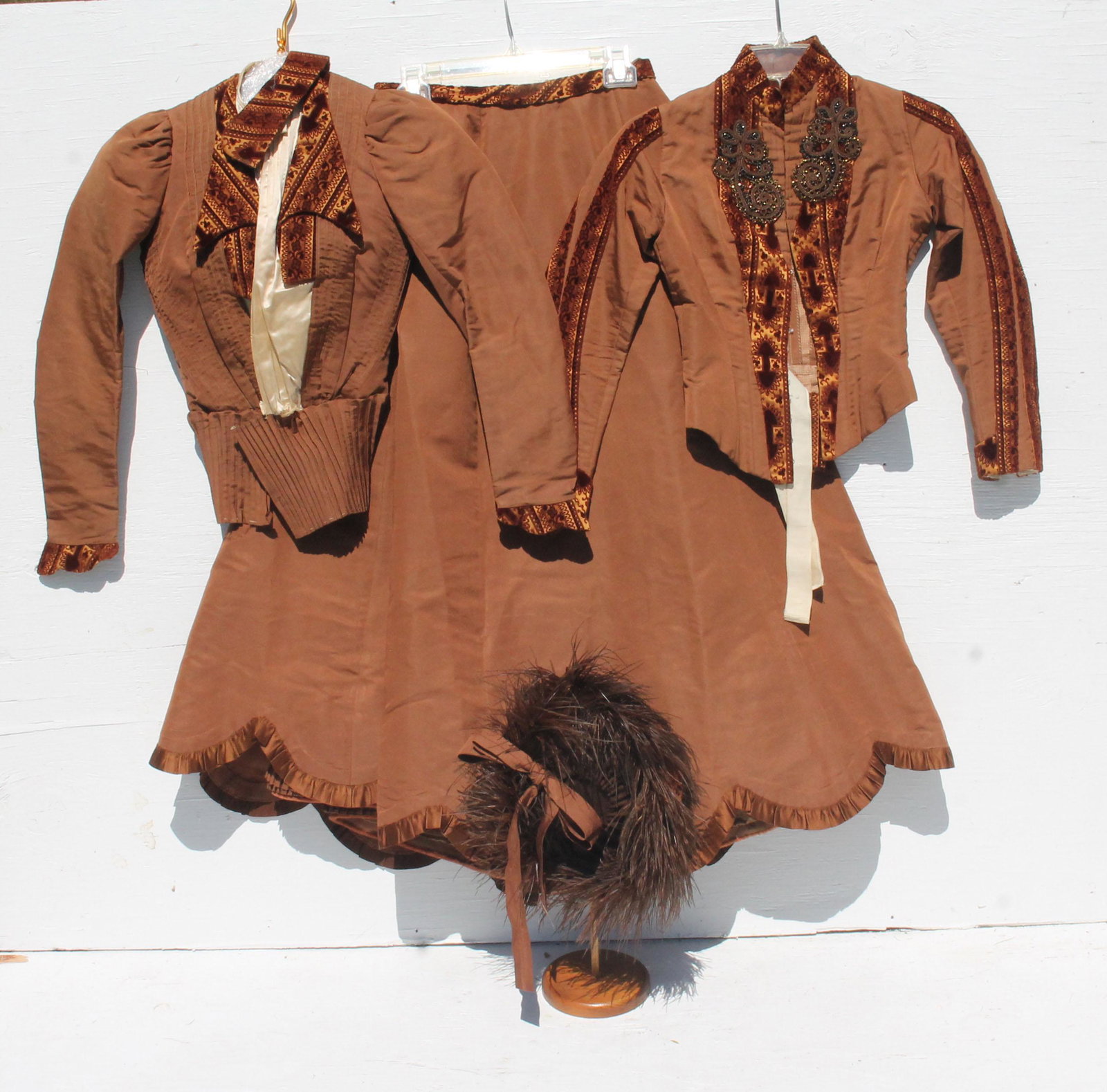 Ca 1870 lady's walking dress and jacket in brown: Ca 1870 lady's walking dress and jacket in brown taffeta and beadwork together with matching felt hat with feather accent