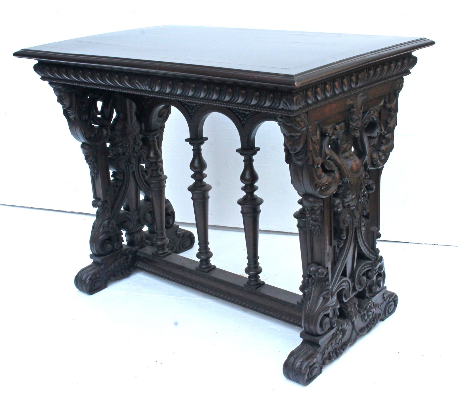 Heavily carved Victorian walnut console table with: Heavily carved Victorian walnut console table with satyr windblower and female figural carvings - top approximately 24x36 - 29" tall