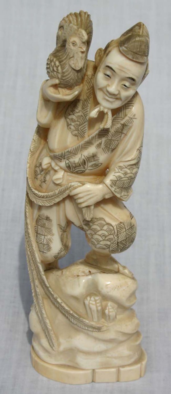 7 1/2" carved ivory figure of a man holding roost
