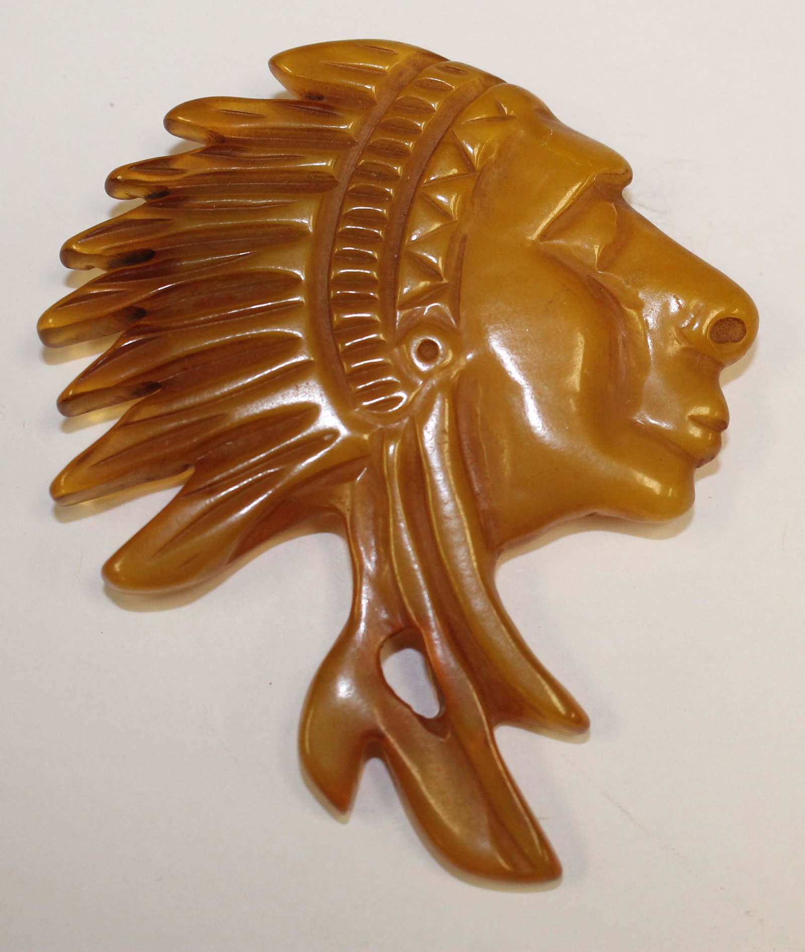 Bakelite reproduction carved Native American form pin: Bakelite reproduction carved Native American form pin - 3 1/4" x 2 3/4"