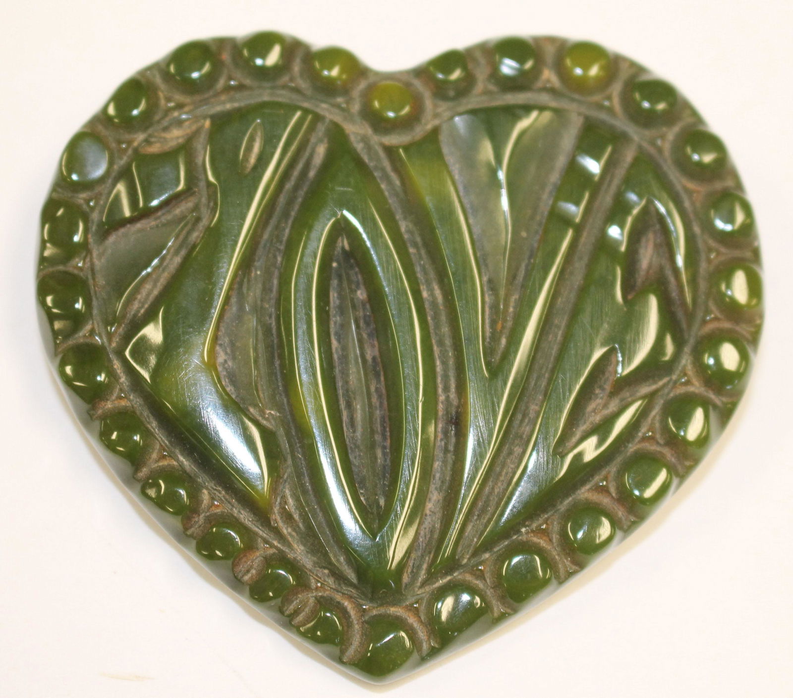 Vintage Bakelite green heart form pin w "Love" carving (1 of 2)