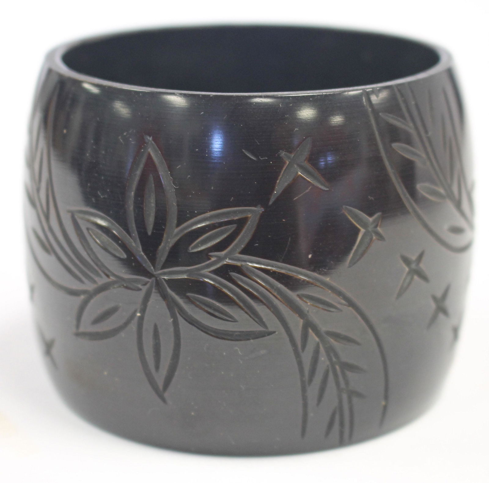 large plastic ebony bangle w carved floral dec: large plastic ebony bangle w carved floral dec - 2 3/4" diam