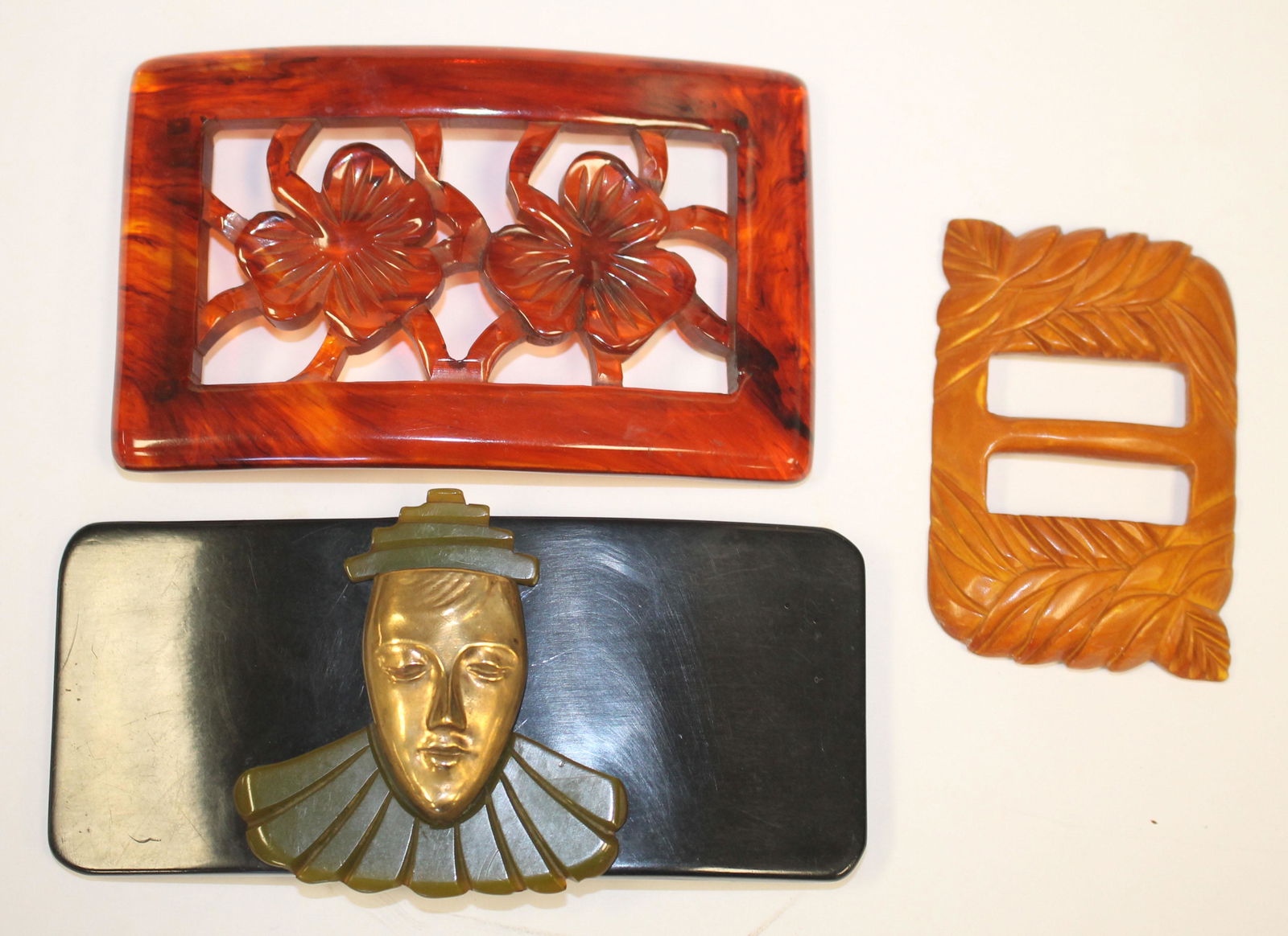 3 Vintage Bakelite belt buckles in butterscotch,: 3 Vintage Bakelite belt buckles in butterscotch, translucent brown & ebony w gold toned metal figural dec - 3" - 5"