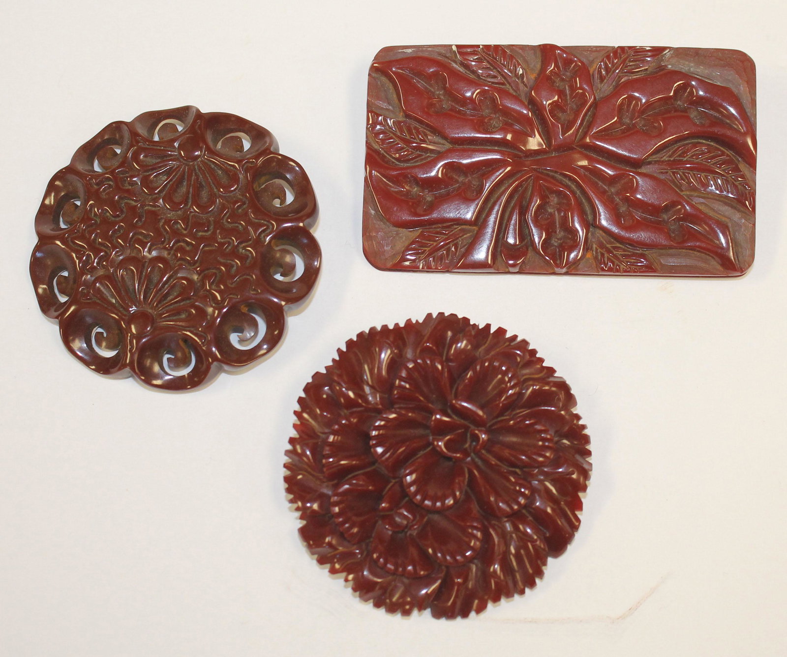 lot of 3 Vintage Bakelite reddisg brown carved floral: lot of 3 Vintage Bakelite reddisg brown carved floral pins - 3 1/4" long plus 2 1/2" diam