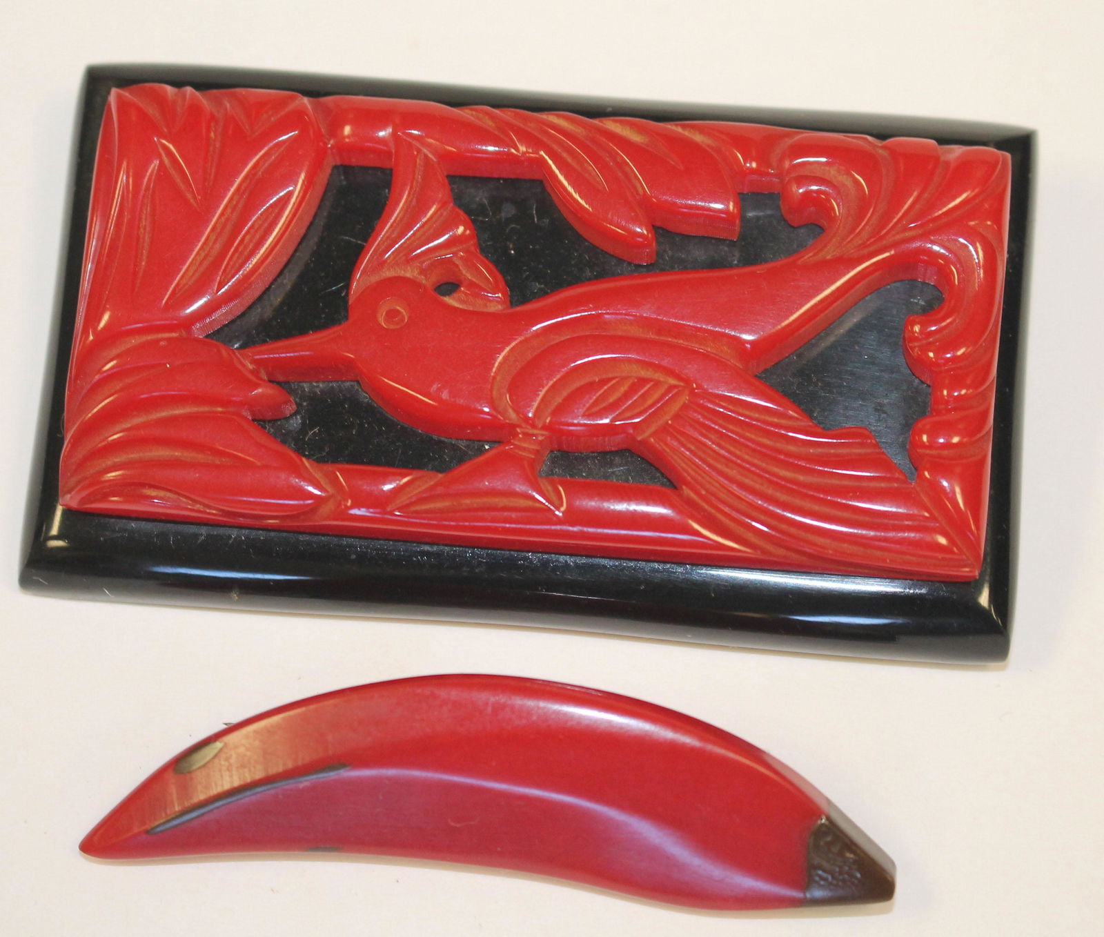 lot of 2 Vintage Bakelite carved red pins incl carved (1 of 2)