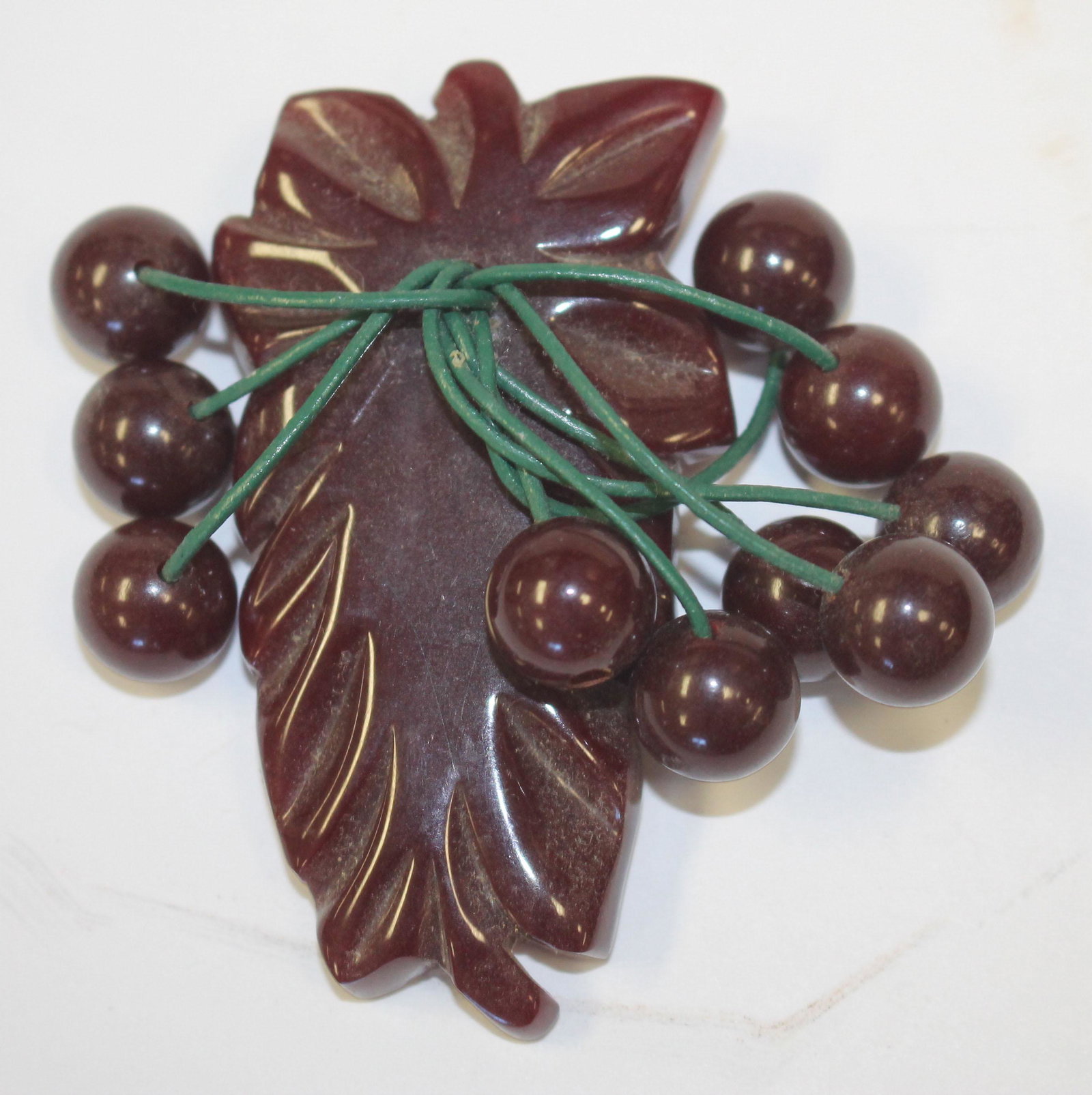 Vintage Bakelite carved brown clip w dangling balls dec: Vintage Bakelite carved brown clip w dangling balls dec - 3"