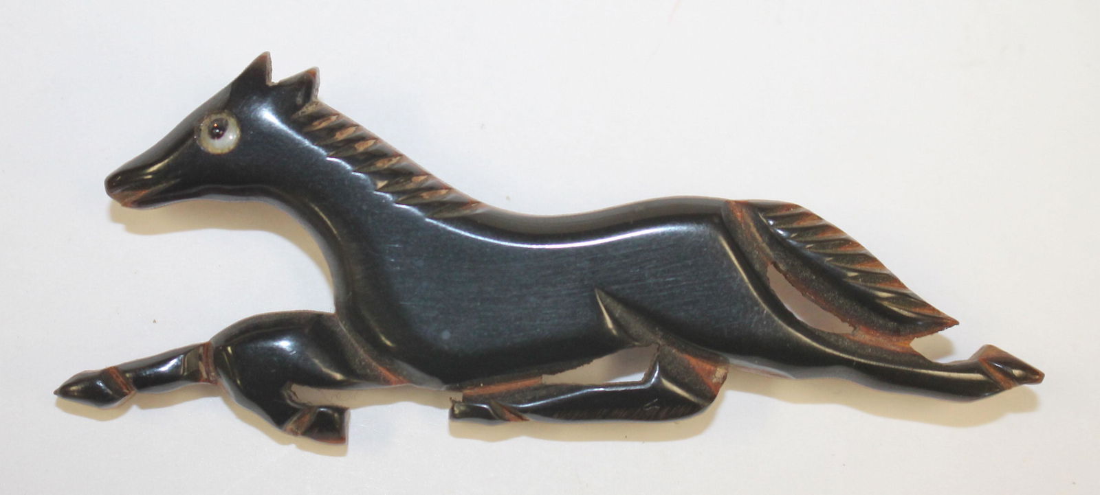 Vintage Bakelite carved ebony & wood running horse pin: Vintage Bakelite carved ebony & wood running horse pin - 3 1/2"