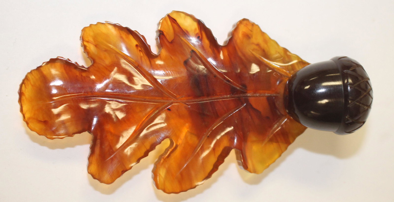 Vintage Bakelite carved traslucent bron oak leaf w: Vintage Bakelite carved traslucent bron oak leaf w applied acorn clip - 3 1/4"