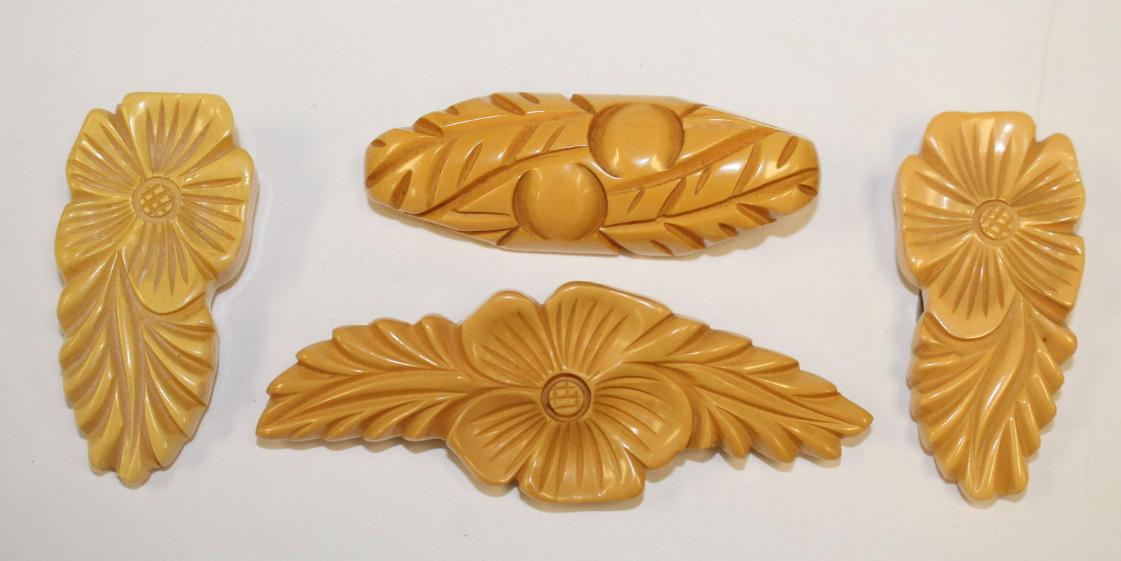 lot of 4 Vintage Bakelite carved floral pins & clips - (1 of 2)