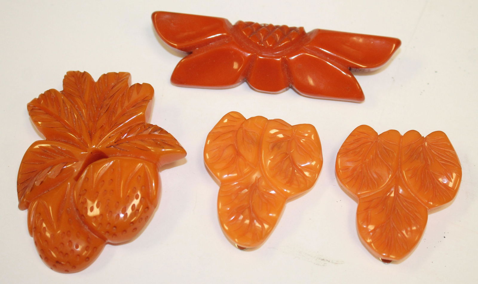 lot of 4 Bakelite orange pins & clips incl carved 3" (1 of 5)