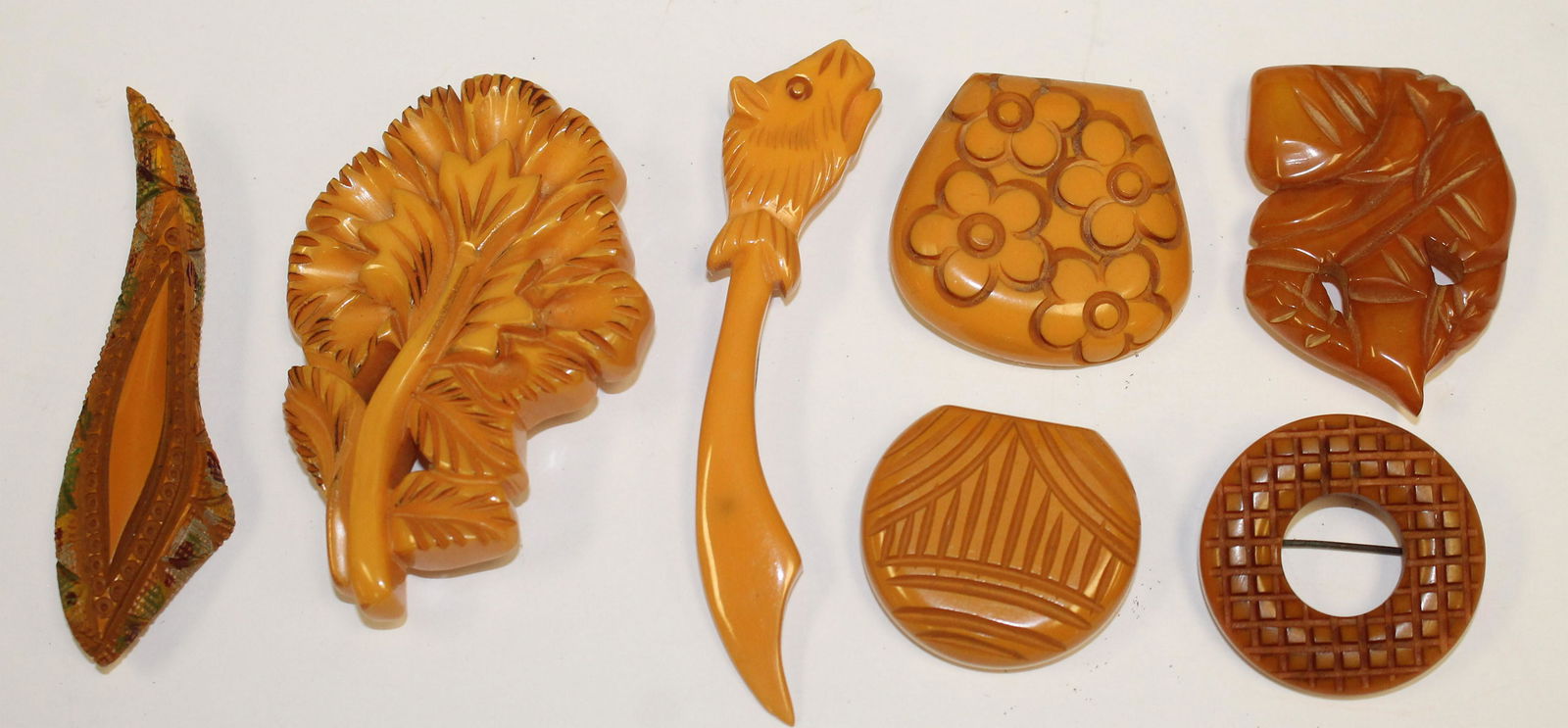 lot of 7 Vintage Bakelite butterscotch/peanutbutter: lot of 7 Vintage Bakelite butterscotch/peanutbutter pins & clips - largest is 4" long, smallest is 1 1/2"