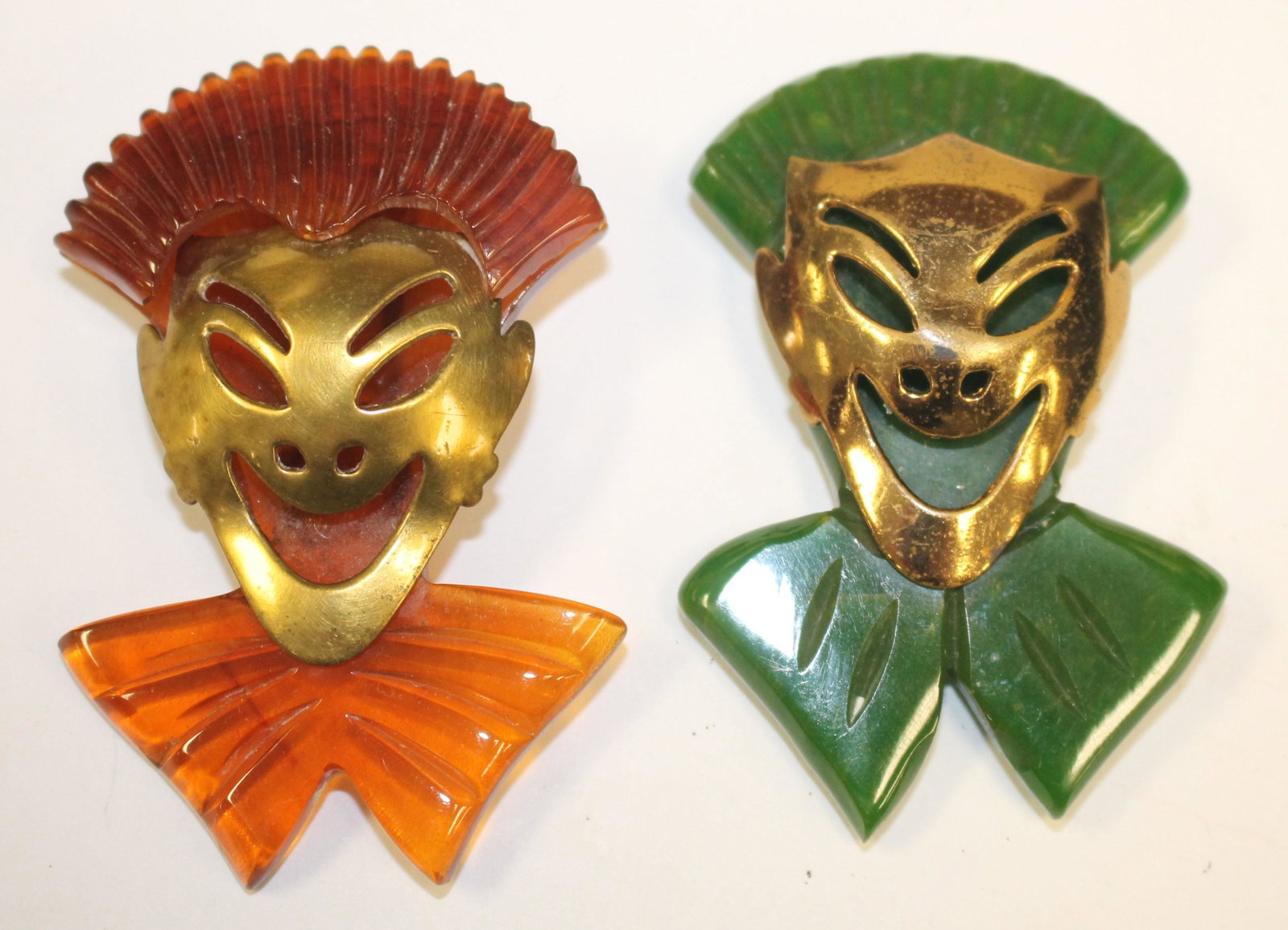 lot of 2 Vintage Bakelite theater face form clips in: lot of 2 Vintage Bakelite theater face form clips in green & brown w gold applied masks - 2 1/2"
