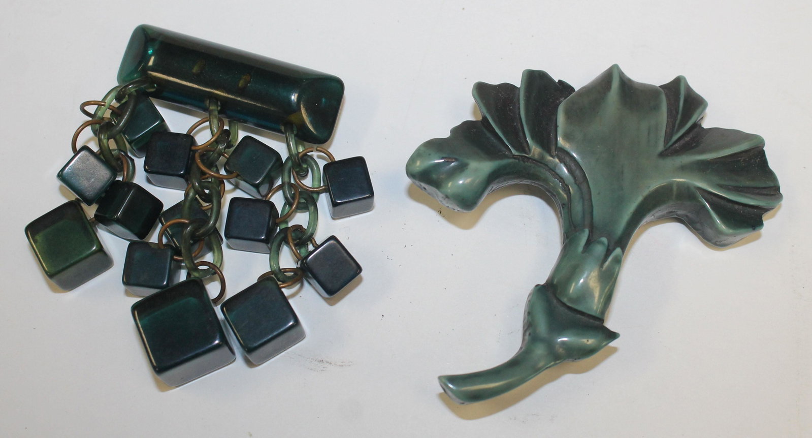 lot of 2 Vintage green pins in Bakelite & Galalith: lot of 2 Vintage Bakelite & Galalith green pins incl carved flower & dangling cubes - 2"-3"