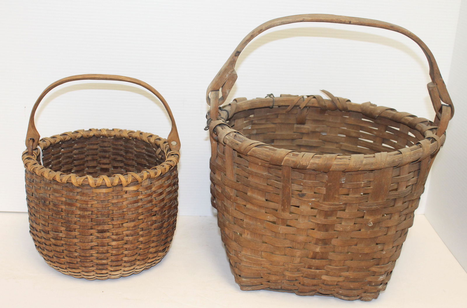 2 Antique New England baskets w swing handles - both as: 2 Antique New England baskets w swing handles - both as found - 6 1/2" tall (not including handle) x 8 3/4" diam & 9" tall (not including handle) x 13" diam