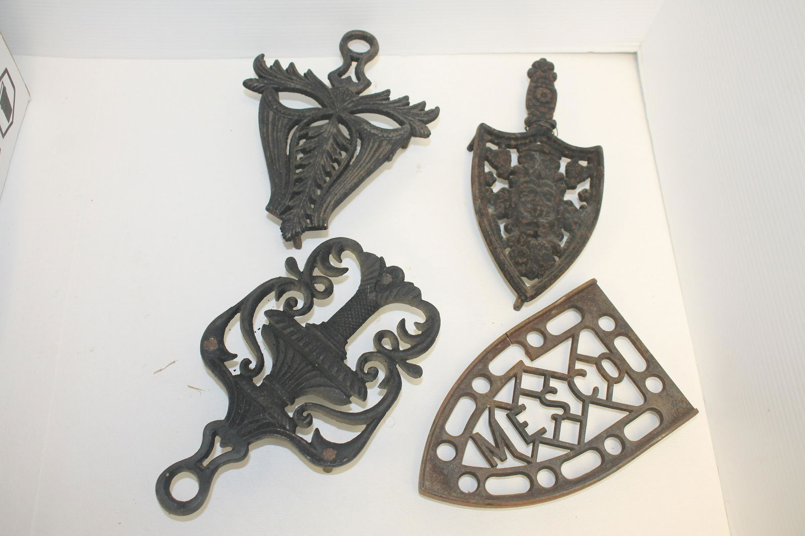 large lot antique iron trivets: large lot antique iron trivets