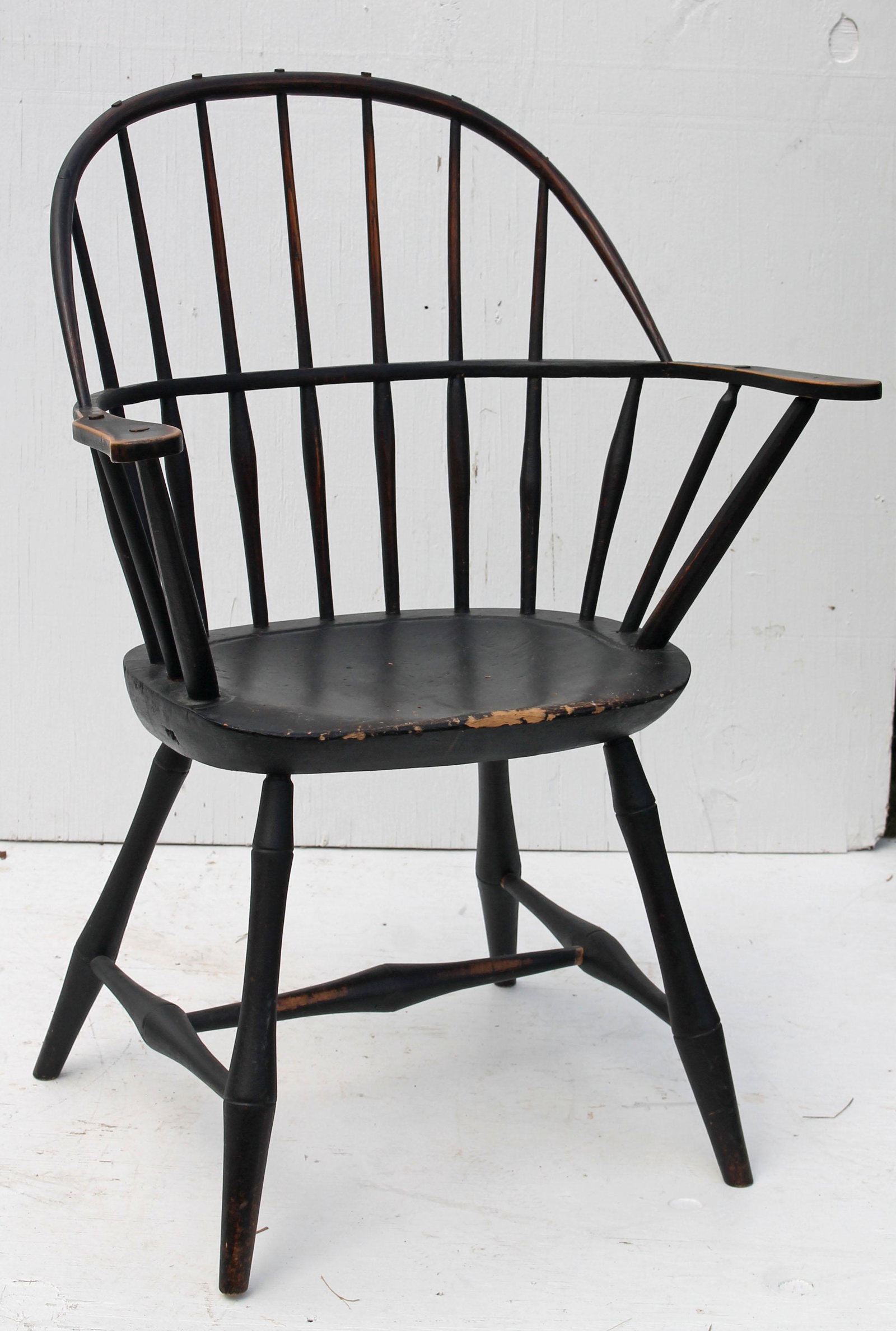 Early 19thC Windsor sack back armchair in black paint: Early 19thC Windsor sack back armchair in black paint - repairs to both arms