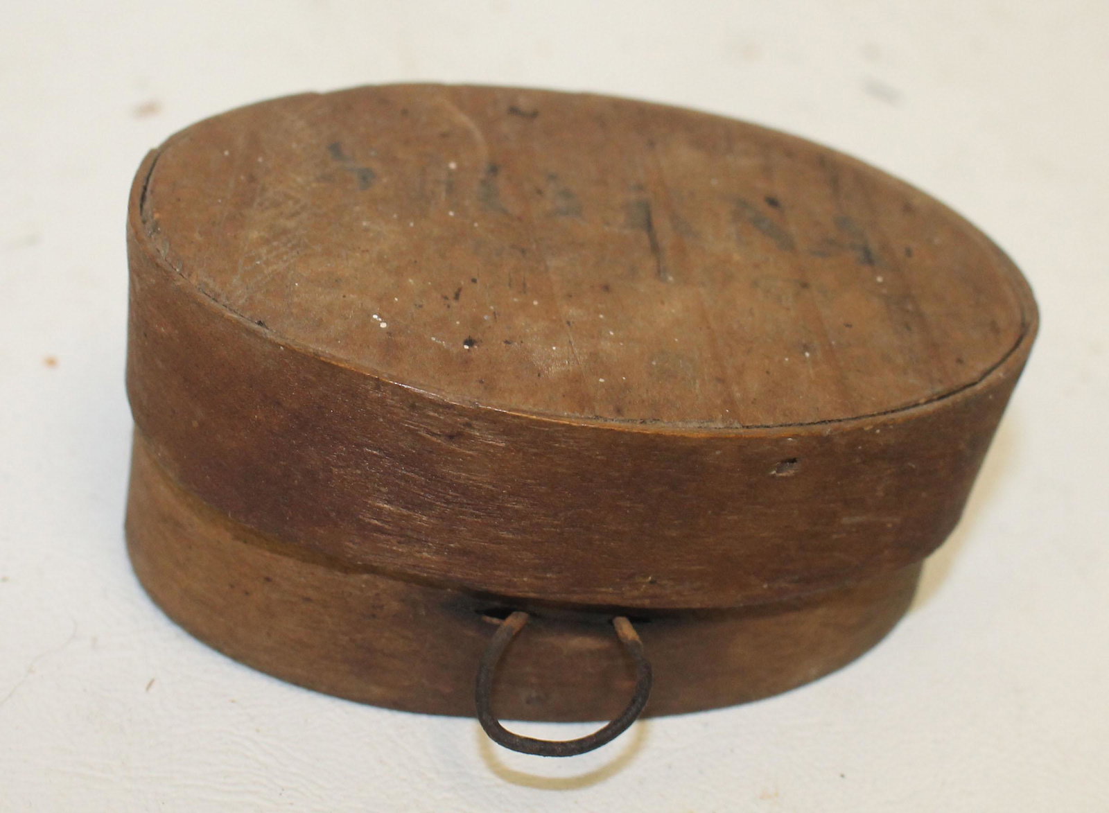 Antique small oval pantry box w 4 marbles inside - has: Antique small oval pantry box w 4 marbles inside - has a make-do iron loop for hanging - 3 3/4"x1 1//2"