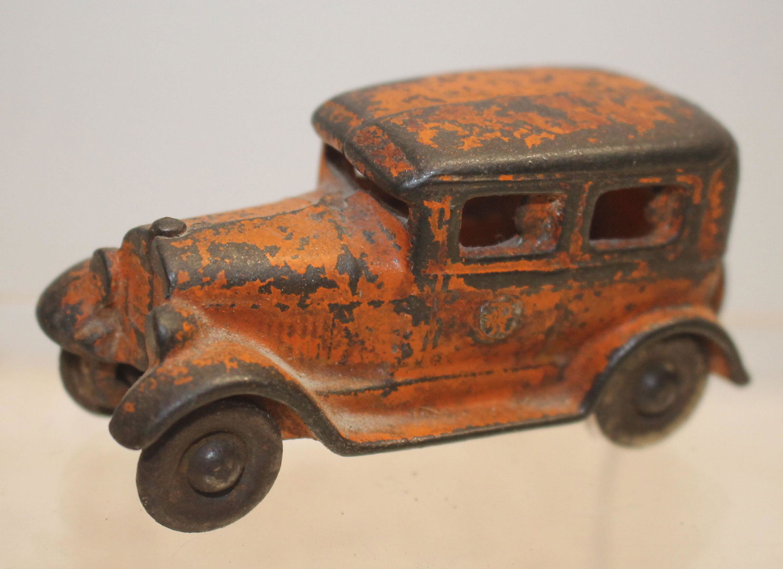 ca 1930's cast iron Kilgore sedan w driver & a: ca 1930's cast iron Kilgore sedan w driver & a passenger in each window in orig orange paint - 3 1/4"